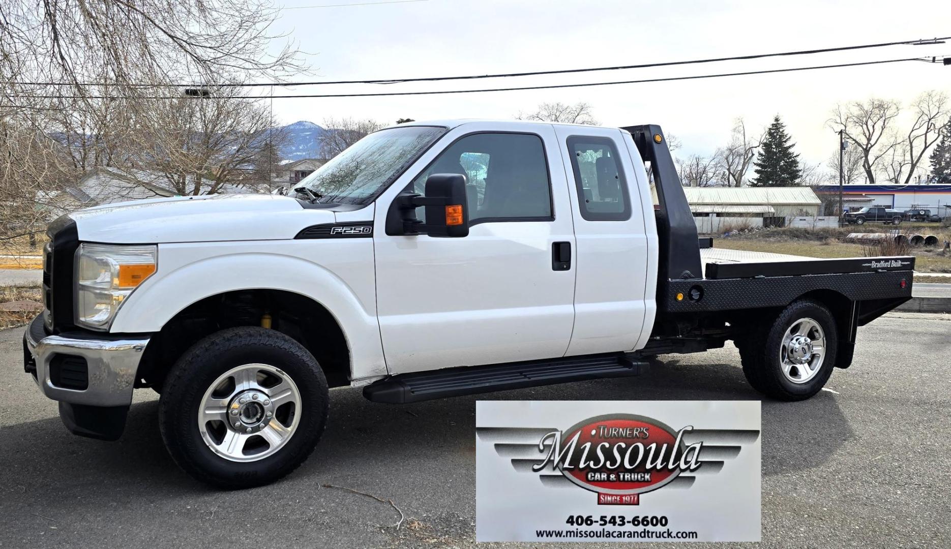 2014 White /Gray Ford F-250 SD XL SuperCab Flatbed 4WD (1FT7X2B62EE) with an 6.2L V8 OHV 16V engine, 6-Speed Automatic transmission, located at 450 N Russell, Missoula, MT, 59801, (406) 543-6600, 46.874496, -114.017433 - Beefy 3/4 Ton Ford 4WD. 6.2L V8 Engine. 6 Speed Automatic Transmission. Nice heavy duty Bradford Flatbed with Gooseneck slot. Deck measures 85" Wide by 102" Long. Air. Cruise. Tilt. Power Windows and Locks. AM FM CD Player. Bluetooth Phone Connection. 4 Wheel Drive has Manual Locking Hubs. Clean Tit - Photo#1