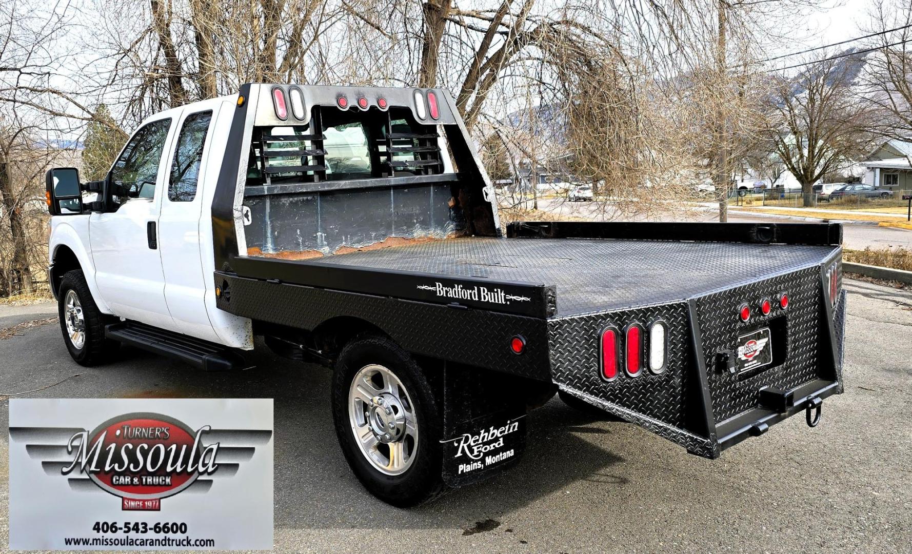 2014 White /Gray Ford F-250 SD XL SuperCab Flatbed 4WD (1FT7X2B62EE) with an 6.2L V8 OHV 16V engine, 6-Speed Automatic transmission, located at 450 N Russell, Missoula, MT, 59801, (406) 543-6600, 46.874496, -114.017433 - Beefy 3/4 Ton Ford 4WD. 6.2L V8 Engine. 6 Speed Automatic Transmission. Nice heavy duty Bradford Flatbed with Gooseneck slot. Deck measures 85" Wide by 102" Long. Air. Cruise. Tilt. Power Windows and Locks. AM FM CD Player. Bluetooth Phone Connection. 4 Wheel Drive has Manual Locking Hubs. Clean Tit - Photo#3