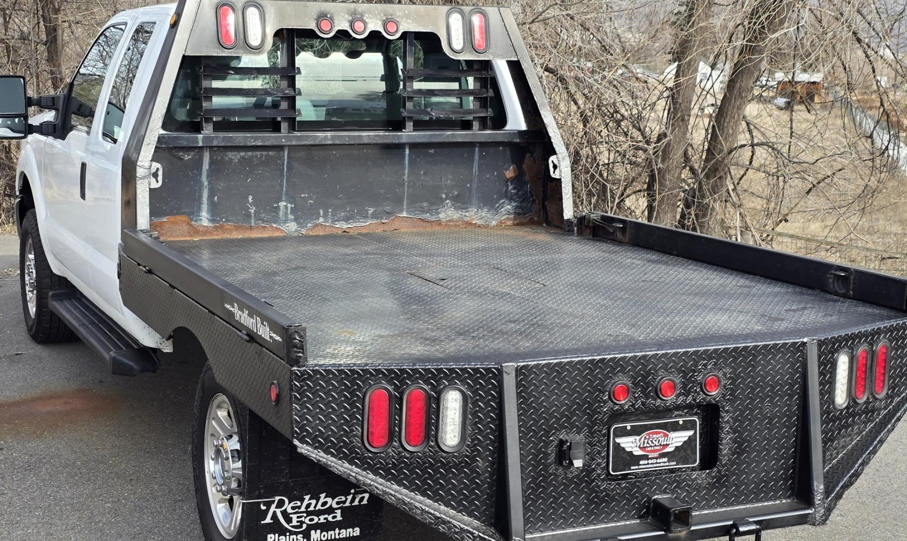 2014 White /Gray Ford F-250 SD XL SuperCab Flatbed 4WD (1FT7X2B62EE) with an 6.2L V8 OHV 16V engine, 6-Speed Automatic transmission, located at 450 N Russell, Missoula, MT, 59801, (406) 543-6600, 46.874496, -114.017433 - Beefy 3/4 Ton Ford 4WD. 6.2L V8 Engine. 6 Speed Automatic Transmission. Nice heavy duty Bradford Flatbed with Gooseneck slot. Deck measures 85" Wide by 102" Long. Air. Cruise. Tilt. Power Windows and Locks. AM FM CD Player. Bluetooth Phone Connection. 4 Wheel Drive has Manual Locking Hubs. Clean Tit - Photo#4