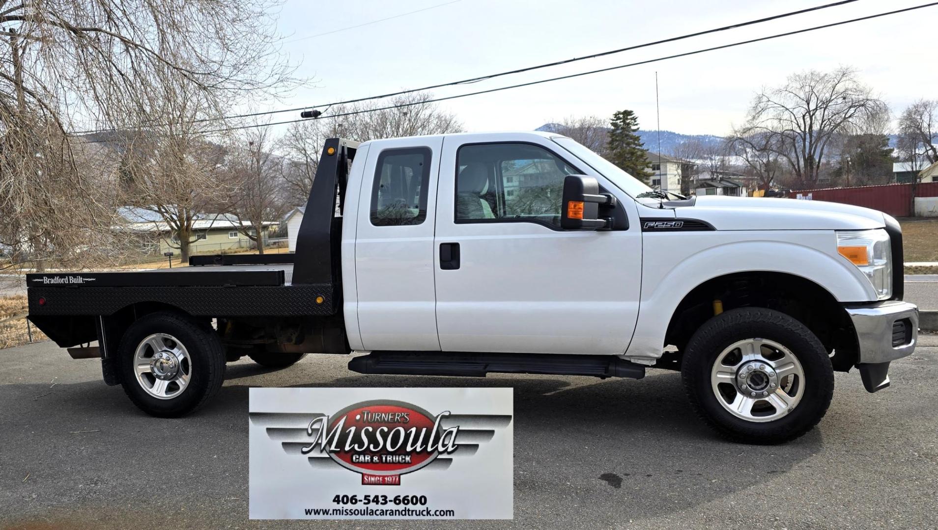2014 White /Gray Ford F-250 SD XL SuperCab Flatbed 4WD (1FT7X2B62EE) with an 6.2L V8 OHV 16V engine, 6-Speed Automatic transmission, located at 450 N Russell, Missoula, MT, 59801, (406) 543-6600, 46.874496, -114.017433 - Beefy 3/4 Ton Ford 4WD. 6.2L V8 Engine. 6 Speed Automatic Transmission. Nice heavy duty Bradford Flatbed with Gooseneck slot. Deck measures 85" Wide by 102" Long. Air. Cruise. Tilt. Power Windows and Locks. AM FM CD Player. Bluetooth Phone Connection. 4 Wheel Drive has Manual Locking Hubs. Clean Tit - Photo#7
