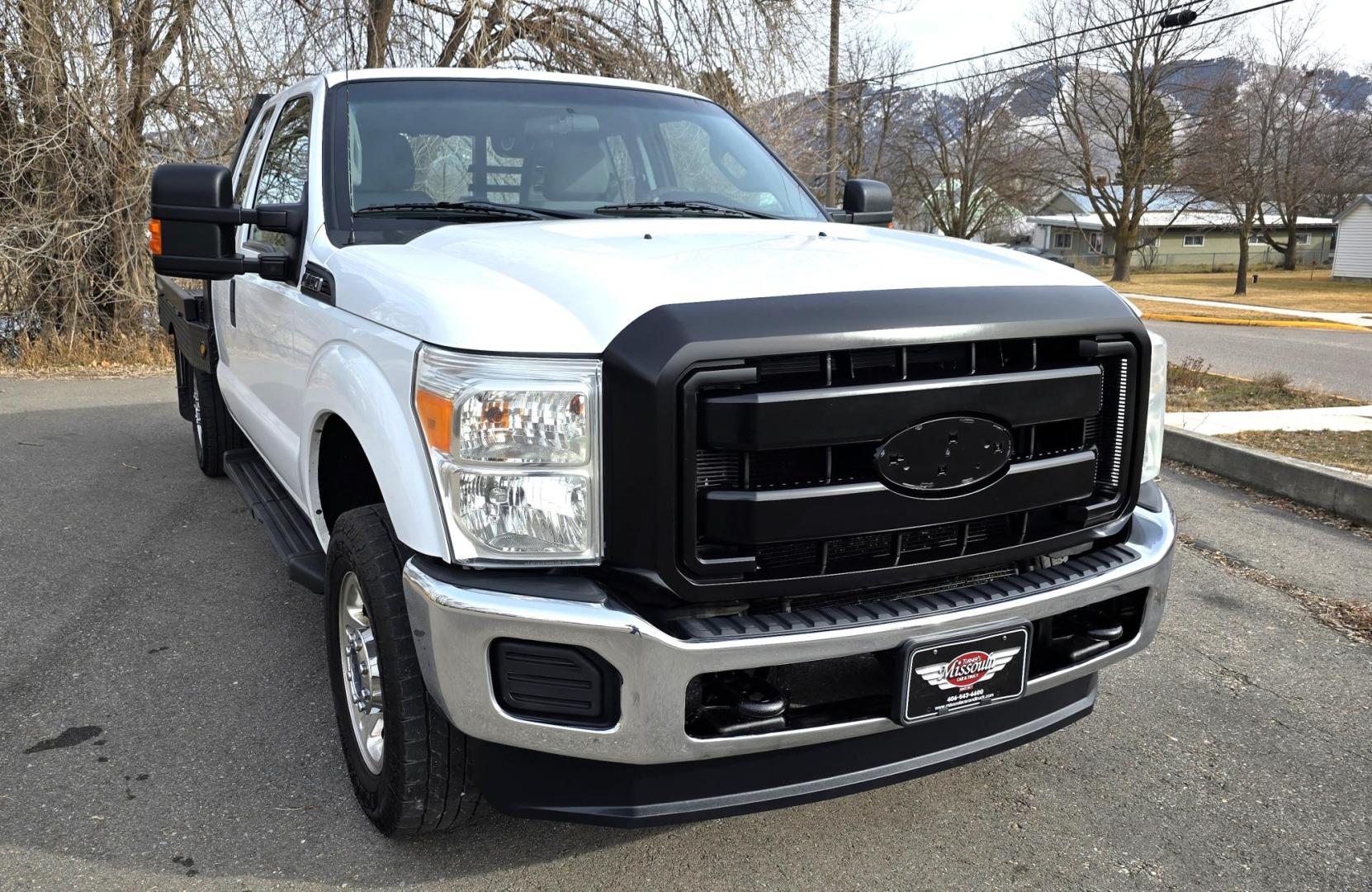 2014 White /Gray Ford F-250 SD XL SuperCab Flatbed 4WD (1FT7X2B62EE) with an 6.2L V8 OHV 16V engine, 6-Speed Automatic transmission, located at 450 N Russell, Missoula, MT, 59801, (406) 543-6600, 46.874496, -114.017433 - Beefy 3/4 Ton Ford 4WD. 6.2L V8 Engine. 6 Speed Automatic Transmission. Nice heavy duty Bradford Flatbed with Gooseneck slot. Deck measures 85" Wide by 102" Long. Air. Cruise. Tilt. Power Windows and Locks. AM FM CD Player. Bluetooth Phone Connection. 4 Wheel Drive has Manual Locking Hubs. Clean Tit - Photo#9