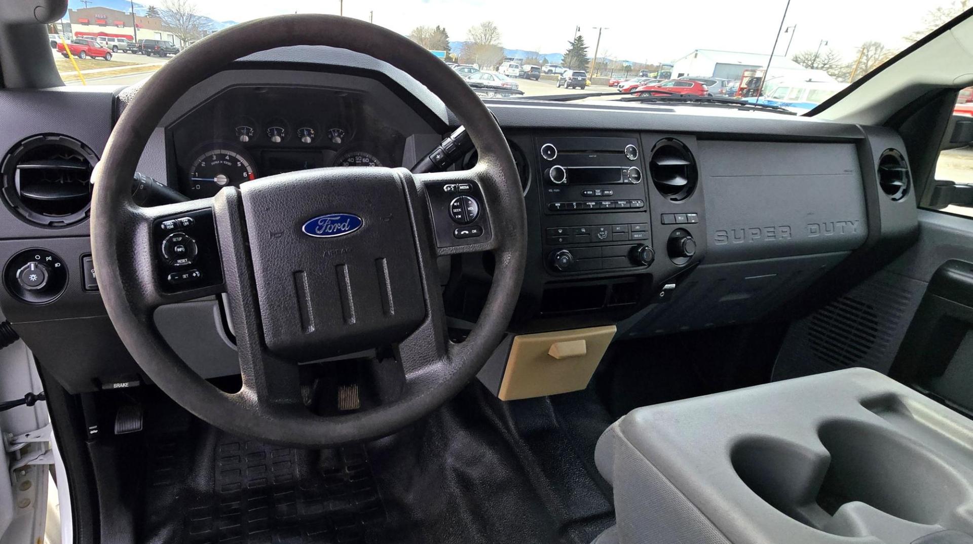 2014 White /Gray Ford F-250 SD XL SuperCab Flatbed 4WD (1FT7X2B62EE) with an 6.2L V8 OHV 16V engine, 6-Speed Automatic transmission, located at 450 N Russell, Missoula, MT, 59801, (406) 543-6600, 46.874496, -114.017433 - Beefy 3/4 Ton Ford 4WD. 6.2L V8 Engine. 6 Speed Automatic Transmission. Nice heavy duty Bradford Flatbed with Gooseneck slot. Deck measures 85" Wide by 102" Long. Air. Cruise. Tilt. Power Windows and Locks. AM FM CD Player. Bluetooth Phone Connection. 4 Wheel Drive has Manual Locking Hubs. Clean Tit - Photo#13