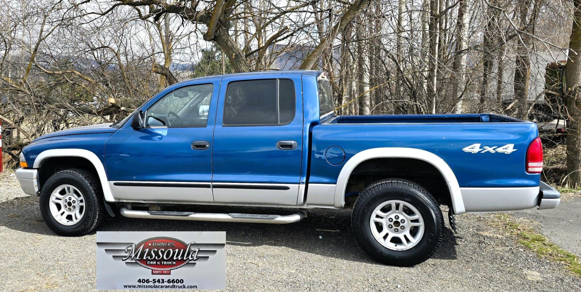 2003 Blue /Gray Dodge Dakota SLT (1D7HG48N63S) with an 4.7L V8 SOHC 16V engine, Automatic with Overdrive transmission, located at 450 N Russell, Missoula, MT, 59801, (406) 543-6600, 46.874496, -114.017433 - Nice mid-size 4WD. 4.7l V8 Offers Power and Economy. Automatic Transmission. Air. Cruise. Tilt. Power Windows and Locks.AM FM CD Player. Excellent Tires. Has a dent on the passenger side and the Center arm Rest is Missing. Because of the age of this vehicle, our lenders do NOT offer financing. - Photo#1