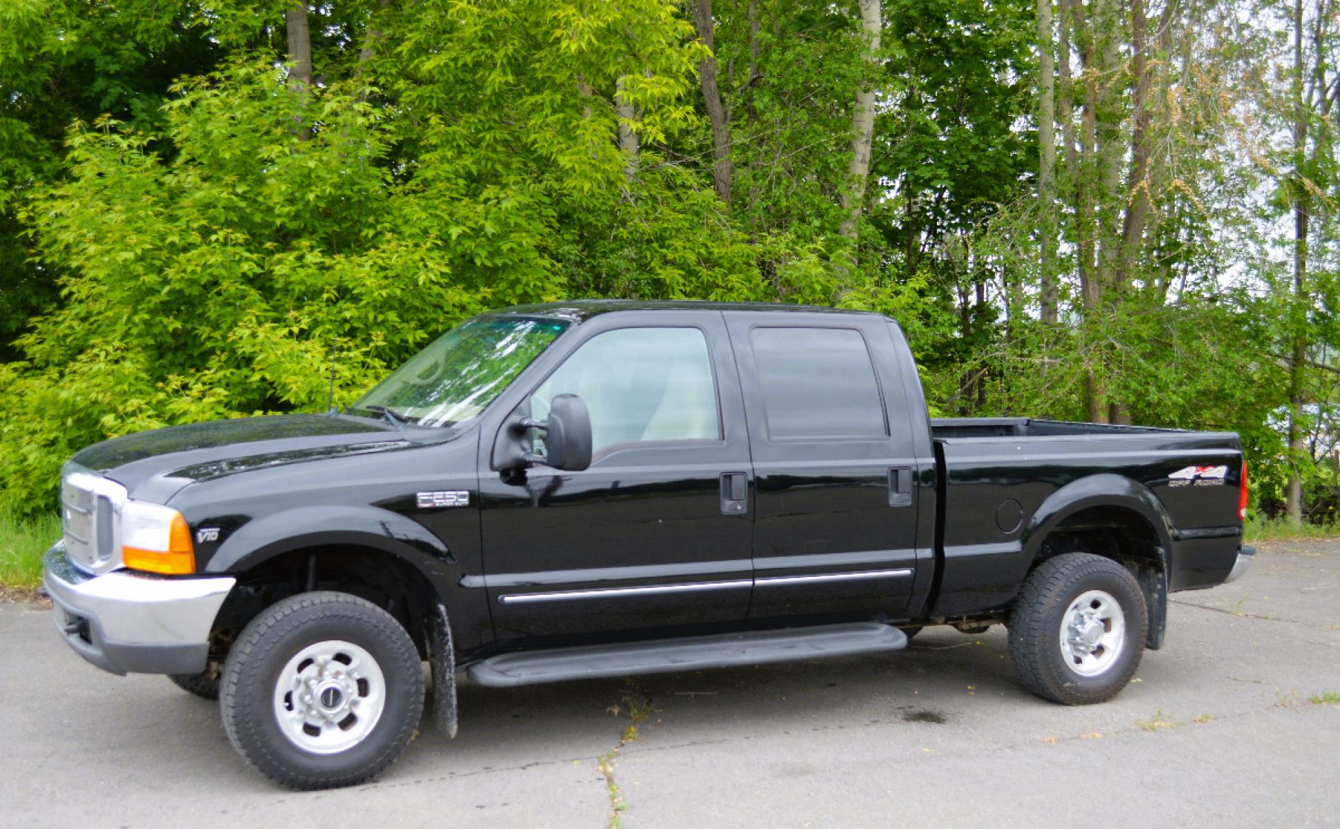 1999 Black Ford F-250 SD Lariat Crew Cab LWB 4WD (1FTNW21S7XE) with an 6.8L V10 SOHC 20V engine, Automatic transmission, located at 450 N Russell, Missoula, MT, 59801, (406) 543-6600, 46.874496, -114.017433 - Great running truck. Had a rebuilt transmission installed at 158K Miles. Has the very desirable Triton V10 Engine. Automatic Transmission. Leather Seats. Air Conditioning. Cruise. Tilt. Bed Liner. Running Boards. - Photo #0