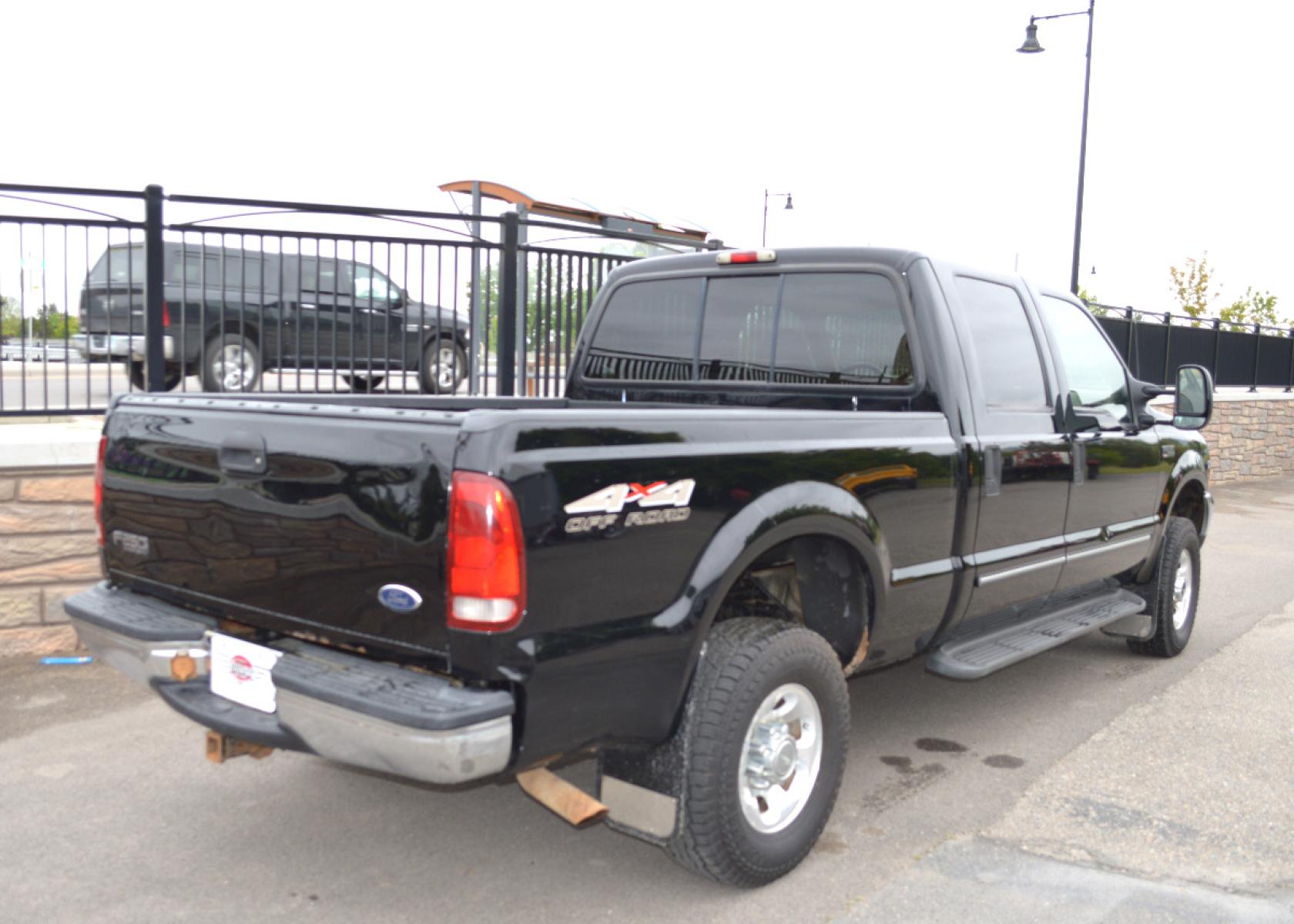 1999 Black Ford F-250 SD Lariat Crew Cab LWB 4WD (1FTNW21S7XE) with an 6.8L V10 SOHC 20V engine, Automatic transmission, located at 450 N Russell, Missoula, MT, 59801, (406) 543-6600, 46.874496, -114.017433 - Great running truck. Had a rebuilt transmission installed at 158K Miles. Has the very desirable Triton V10 Engine. Automatic Transmission. Leather Seats. Air Conditioning. Cruise. Tilt. Bed Liner. Running Boards. - Photo #3