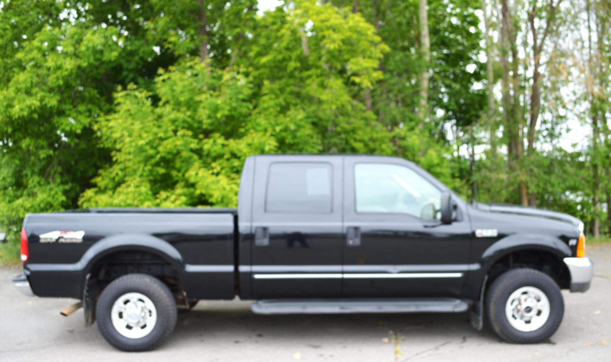 1999 Black Ford F-250 SD Lariat Crew Cab LWB 4WD (1FTNW21S7XE) with an 6.8L V10 SOHC 20V engine, Automatic transmission, located at 450 N Russell, Missoula, MT, 59801, (406) 543-6600, 46.874496, -114.017433 - Great running truck. Had a rebuilt transmission installed at 158K Miles. Has the very desirable Triton V10 Engine. Automatic Transmission. Leather Seats. Air Conditioning. Cruise. Tilt. Bed Liner. Running Boards. - Photo #6