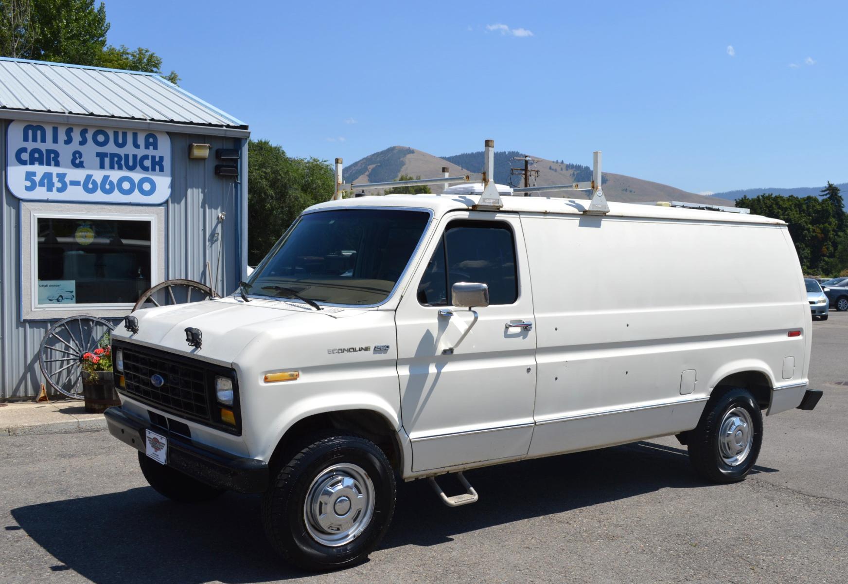 1990 White /Black Ford Econoline E250 (1FTFE24H6LH) with an 5.8L V8 OHV 16V engine, 4-Speed Automatic Overdrive transmission, located at 450 N Russell, Missoula, MT, 59801, (406) 543-6600, 46.874496, -114.017433 - Converted 3/4 Ton Ford Van. Has solar panels on top with a converter for power inside. Had a fold out bed. Comes with a sink that you hook to a 5 gallon water jug. Runs great. This vehicle is more then 20 years old and is not eligible for lending through our finance companies. - Photo #0