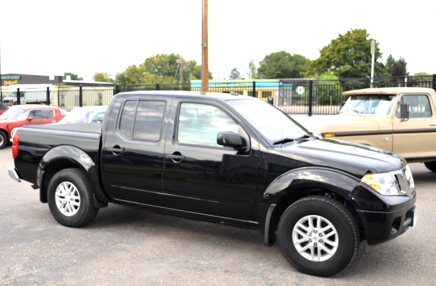 2017 Black /Tan Nissan Frontier SL Crew Cab 5AT 2WD (1N6AD0ER4HN) with an 4.0L V6 DOHC 24V engine, 5A transmission, located at 450 N Russell, Missoula, MT, 59801, (406) 543-6600, 46.874496, -114.017433 - Automatic Transmission, Heated Seats. Air. Cruise. Tilt. Power Windows and Locks. AM FM XM CD Player. Bluetooth. Backup Camera. Bed Liner. Towing. Tonneau Cover. - Photo #1