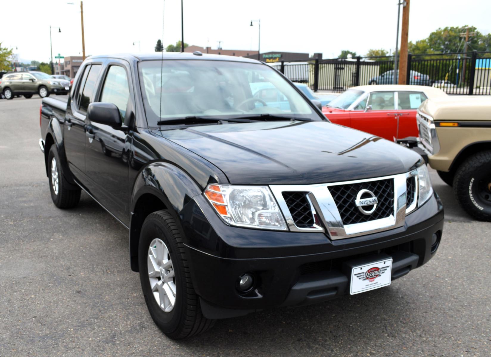 2017 Black /Tan Nissan Frontier SL Crew Cab 5AT 2WD (1N6AD0ER4HN) with an 4.0L V6 DOHC 24V engine, 5A transmission, located at 450 N Russell, Missoula, MT, 59801, (406) 543-6600, 46.874496, -114.017433 - Automatic Transmission, Heated Seats. Air. Cruise. Tilt. Power Windows and Locks. AM FM XM CD Player. Bluetooth. Backup Camera. Bed Liner. Towing. Tonneau Cover. - Photo #2
