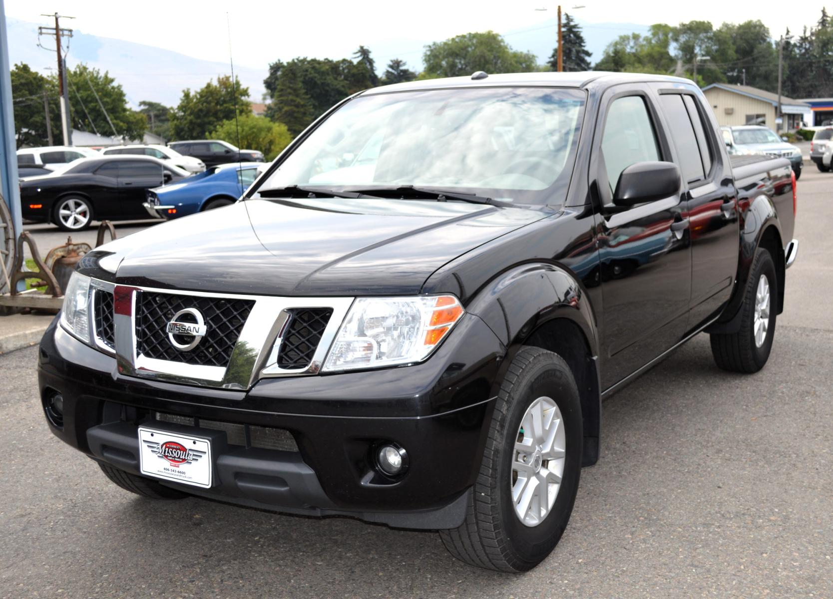 2017 Black /Tan Nissan Frontier SL Crew Cab 5AT 2WD (1N6AD0ER4HN) with an 4.0L V6 DOHC 24V engine, 5A transmission, located at 450 N Russell, Missoula, MT, 59801, (406) 543-6600, 46.874496, -114.017433 - Automatic Transmission, Heated Seats. Air. Cruise. Tilt. Power Windows and Locks. AM FM XM CD Player. Bluetooth. Backup Camera. Bed Liner. Towing. Tonneau Cover. - Photo #4