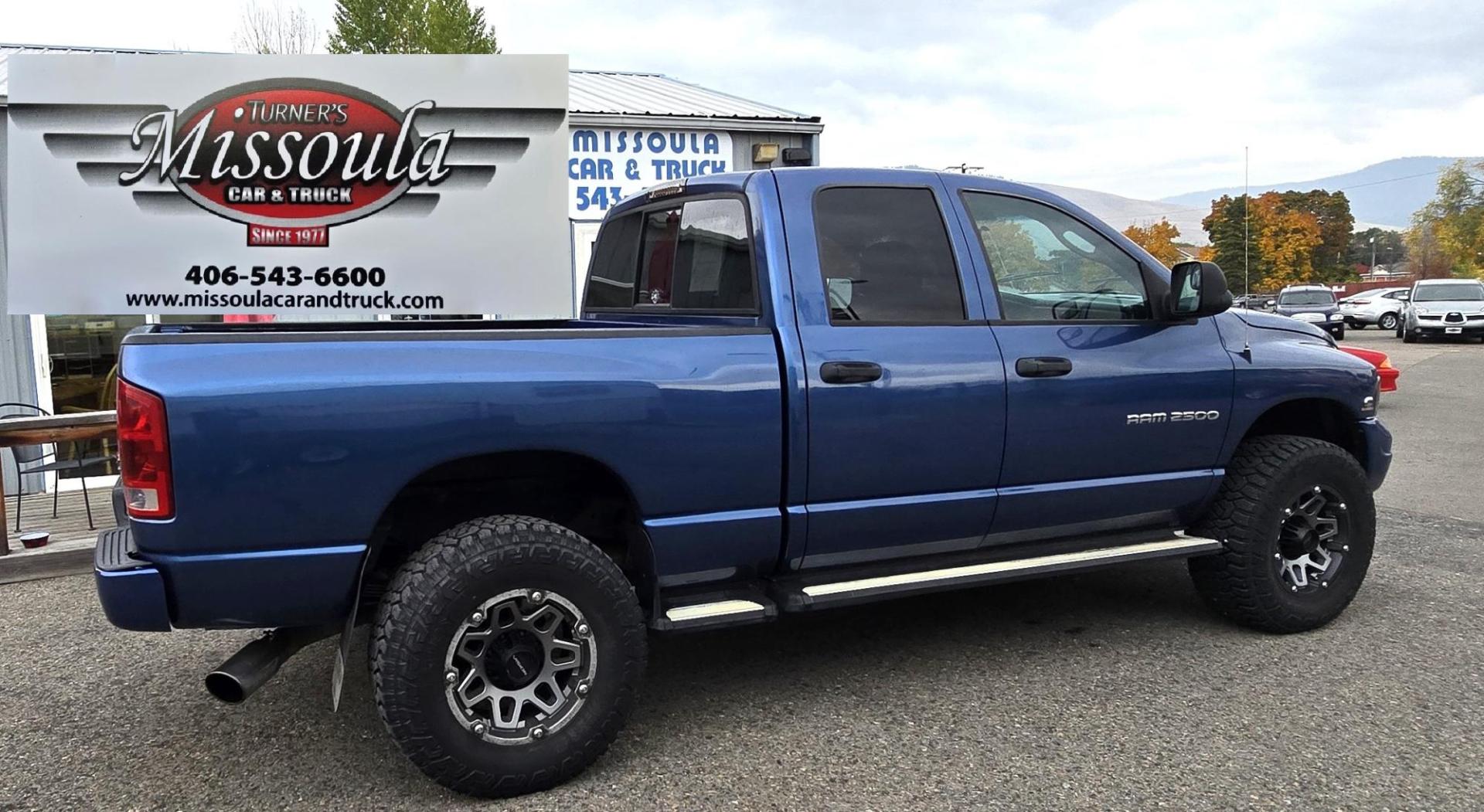 2003 Blue /Black Dodge Ram 2500 Laramie Quad Cab Long Bed 4WD (3D7KU28C13G) with an 5.9L L6 OHV 24V TURBO DIESEL engine, 6 Speed Manual transmission, located at 450 N Russell, Missoula, MT, 59801, (406) 543-6600, 46.874496, -114.017433 - Very Nice 5.9 Diesel 4WD Pickup. Hard to find 6 Speed Manual Transmission. Great Miles for it's age. Air Cruise. Tilt. Power Windows and Locks. Power Drivers Seat. Running Boards. Nice Tires and Wheels. Towing. Because of the age of this vehicle, financing is NOT available. - Photo#1