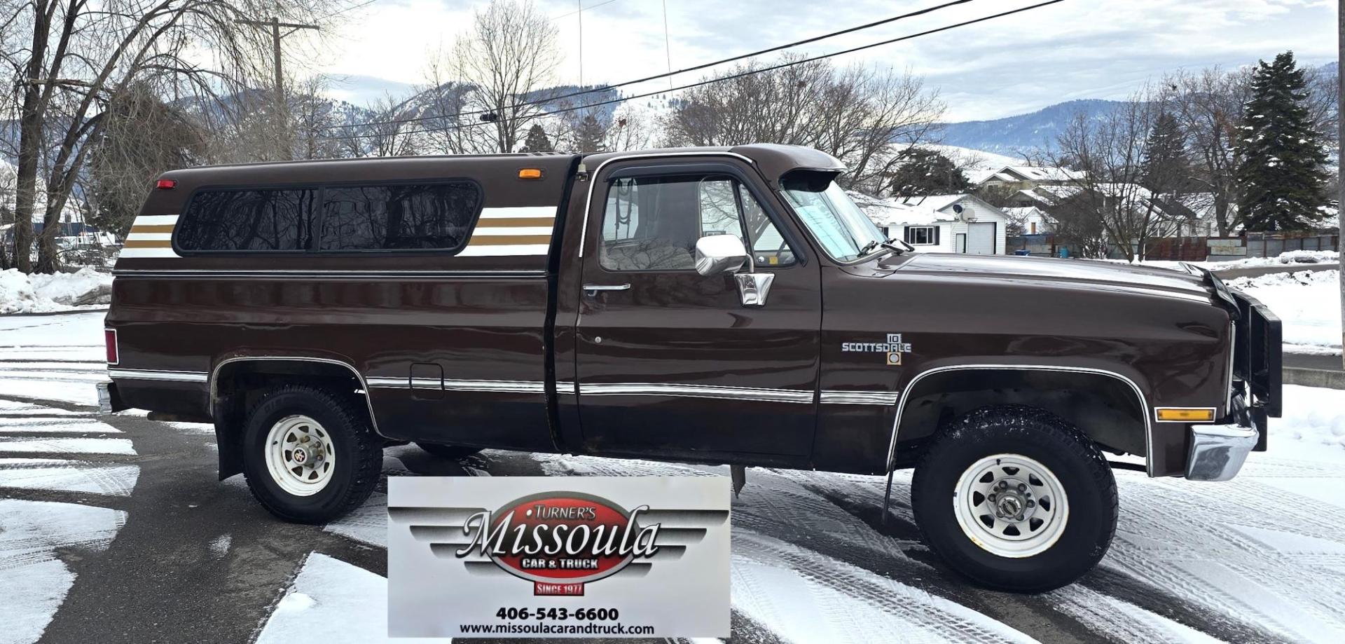 1984 Brown /Tan Chevrolet C/K 10 Custom Deluxe 4WD (1GCEK14H3EJ) with an 5.0L V8 OHV engine, 4 Speed Manual transmission, located at 450 N Russell, Missoula, MT, 59801, (406) 543-6600, 46.874496, -114.017433 - Nice old Square Body 4WD. Brand NEW Tires. Matching Topper. 4 Speed Manual Transmission. 305 V8 Engine. Dual Gas Tanks. Runs amazing. Not perfect but good for it's age. - Photo#1