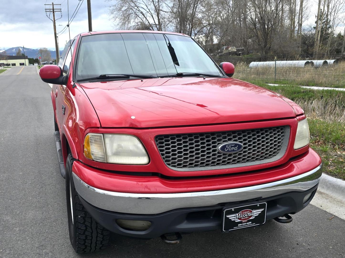 2000 Red /Tan Ford F-150 Lariat SuperCab 4WD (1FTRX18L1YN) with an 5.4L V8 SOHC 16V engine, 4-Speed Automatic Overdrive transmission, located at 450 N Russell, Missoula, MT, 59801, (406) 543-6600, 46.874496, -114.017433 - Strong Running 4WD Truck. 5.4L V8 Engine. Automatic Transmission. 4 Doors. Air. Cruise. Tilt. Power Windows and Locks. Aftermarket AM FM CD Player. Bedliner. Running Boards. Because of the age, financing is not available through our lenders. - Photo#3