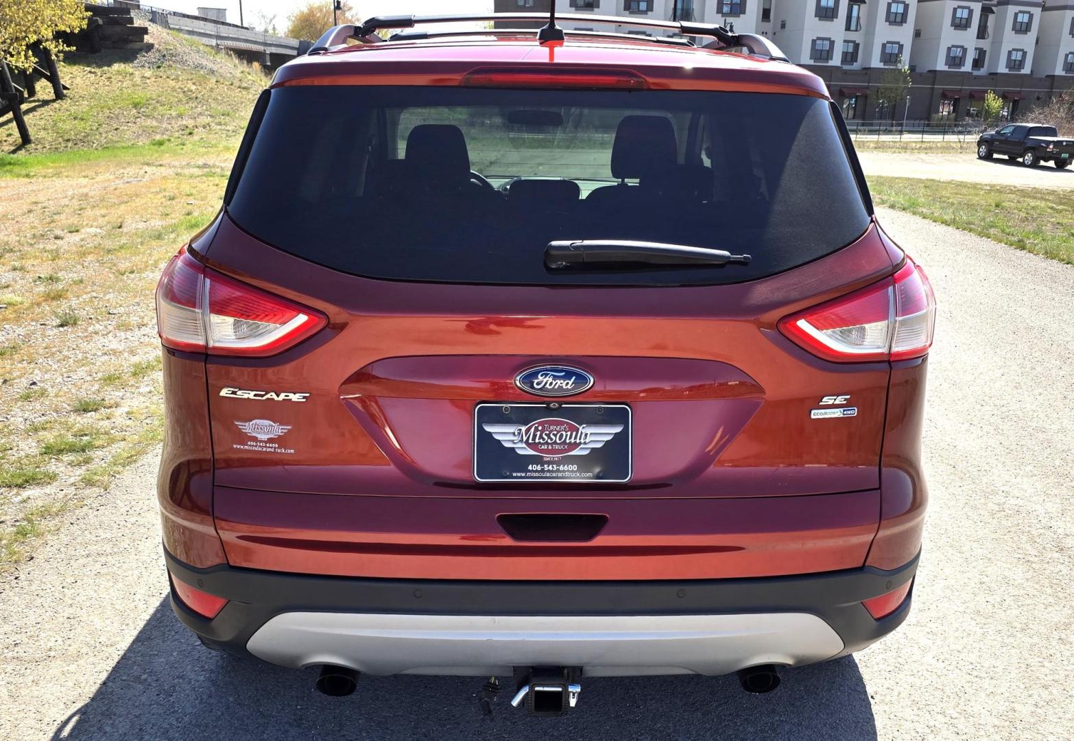 2014 Orange /Gray Ford Escape SE 4WD (1FMCU9G94EU) with an 2.0L L4 DOHC 16V engine, 6-Speed Automatic transmission, located at 450 N Russell, Missoula, MT, 59801, (406) 543-6600, 46.874496, -114.017433 - Beautiful Ford Escape. AWD. Official Color is Sunset Metallic. 2.0L I4 Engine. Automatic Transmission. Air. Cruise. Tilt. Bluetooth Audio and Phone. Backup Camera. Power Windows and Locks. AM FM SAT CD Player. Roof Rack. Towing. - Photo#7