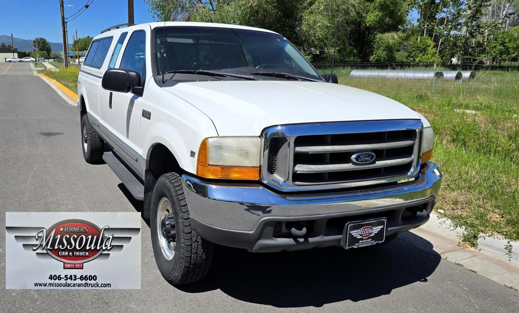 1999 White /Gray Ford F-250 SD Lariat SuperCab LWB 4WD (1FTNX21S9XE) with an 6.8L V10 SOHC 20V engine, Automatic transmission, located at 450 N Russell, Missoula, MT, 59801, (406) 543-6600, 46.874496, -114.017433 - Nice Owner Owner Truck with a Clean Carfax. Only 120,700 Miles. Powerful, Reliable V10 Engine. Automatic Transmission. 4WD with Locking Hubs. Long Box with Matching Topper. Power Drivers Seat. Air. Cruise. Tilt. Power Windows and Locks. AM FM Cassette CD Player. CB Radio. Because of the age, or L - Photo#2