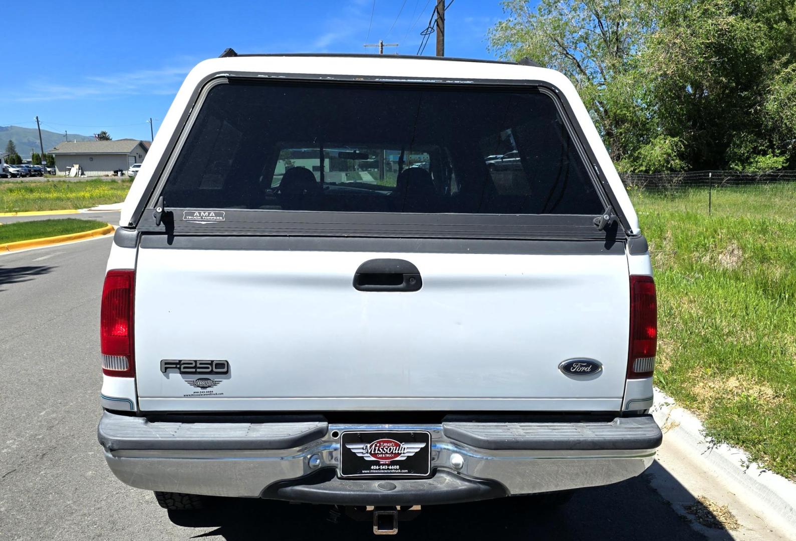 1999 White /Gray Ford F-250 SD Lariat SuperCab LWB 4WD (1FTNX21S9XE) with an 6.8L V10 SOHC 20V engine, Automatic transmission, located at 450 N Russell, Missoula, MT, 59801, (406) 543-6600, 46.874496, -114.017433 - Nice Owner Owner Truck with a Clean Carfax. Only 120,700 Miles. Powerful, Reliable V10 Engine. Automatic Transmission. 4WD with Locking Hubs. Long Box with Matching Topper. Power Drivers Seat. Air. Cruise. Tilt. Power Windows and Locks. AM FM Cassette CD Player. CB Radio. Because of the age, or L - Photo#9