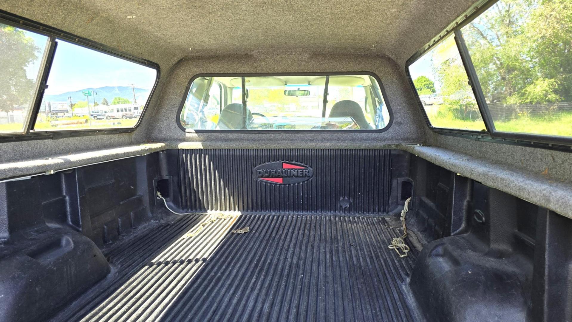 1999 White /Gray Ford F-250 SD Lariat SuperCab LWB 4WD (1FTNX21S9XE) with an 6.8L V10 SOHC 20V engine, Automatic transmission, located at 450 N Russell, Missoula, MT, 59801, (406) 543-6600, 46.874496, -114.017433 - Nice Owner Owner Truck with a Clean Carfax. Only 120,700 Miles. Powerful, Reliable V10 Engine. Automatic Transmission. 4WD with Locking Hubs. Long Box with Matching Topper. Power Drivers Seat. Air. Cruise. Tilt. Power Windows and Locks. AM FM Cassette CD Player. CB Radio. Because of the age, or L - Photo#10