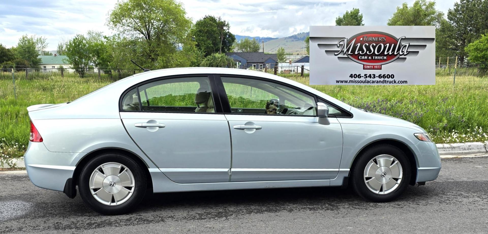 2006 Blue /Gray Honda Civic Hybrid CVT (JHMFA36256S) with an 1.3L L4 SOHC 8V HYBRID engine, Automatic CVT Overdrive transmission, located at 450 N Russell, Missoula, MT, 59801, (406) 543-6600, 46.874496, -114.017433 - Great Fuel Economy for a low price. 1.3L I4 Hybrid. Automatic Transmission. Air. Cruise. Tilt. Power Windows and Locks. It has a maintenance light on, but that's only because the reset button isn't working for days since last oil change. Has a couple dings and a crack in the rear bumper. Well below - Photo#0