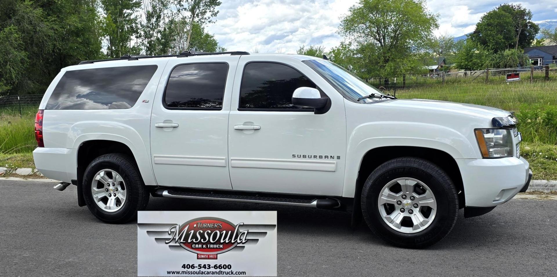 2009 White /Black Chevrolet Suburban LT1 1500 4WD (1GNFK26319R) with an 5.3L V8 OHV 16V FFV engine, 4-Speed Automatic transmission, located at 450 N Russell, Missoula, MT, 59801, (406) 543-6600, 46.874496, -114.017433 - Big Sexy 4WD SUV in Excellent Condition. 5.3L V8 Engine. 3rd Row Seating. Leather Seats. Heated Front and Middle Seats. Rear Entertainment. Power Sunroof. Power Liftgate. Front and Rear Climate Control. Towing. Running Boards. AM FM XM CD DVD and Navigation. Excellent Michelin Tires. We Finance - Photo#1