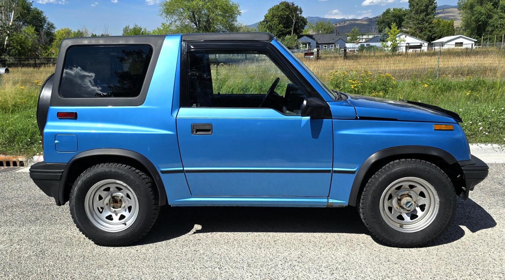 1995 Blue /Blue Geo Tracker 2-Door 4WD (2CNBJ186XS6) with an 1.6L L4 SOHC 16V engine, located at 450 N Russell, Missoula, MT, 59801, (406) 543-6600, 46.874496, -114.017433 - Cute as a Bug. 4WD GEO Tracker. Impossible to find in this condition. 1.6L I4 Engine. 5 Speed Manual Transmission. Locking Hubs. Tops come off for those hot days in the Mountains. Comes with an extra set of tires and wheels. Try to find another Tracker as nice as this for this price. Because of - Photo#1