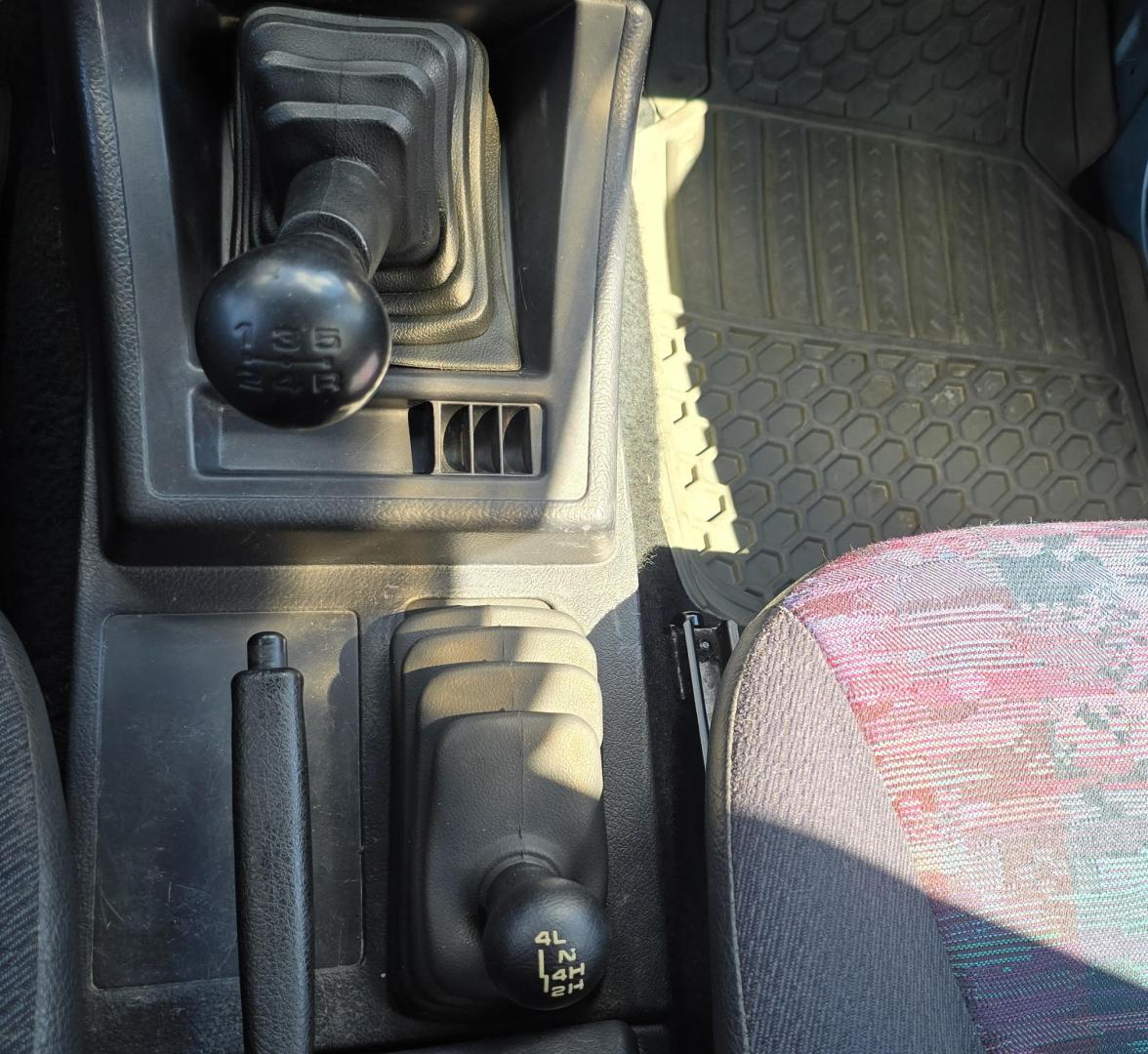 1995 Blue /Blue Geo Tracker 2-Door 4WD (2CNBJ186XS6) with an 1.6L L4 SOHC 16V engine, located at 450 N Russell, Missoula, MT, 59801, (406) 543-6600, 46.874496, -114.017433 - Cute as a Bug. 4WD GEO Tracker. Impossible to find in this condition. 1.6L I4 Engine. 5 Speed Manual Transmission. Locking Hubs. Tops come off for those hot days in the Mountains. Comes with an extra set of tires and wheels. Try to find another Tracker as nice as this for this price. Because of - Photo#14