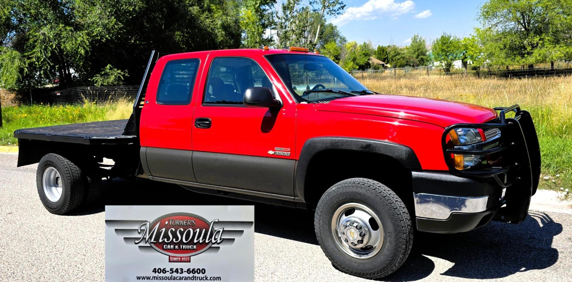 2004 Red /Gray Chevrolet Silverado 3500 Ext. Cab 4WD (1GCJK392X4E) with an 6.6L V8 OHV 32V TURBO DIESEL engine, 6 Speed Manual transmission, located at 450 N Russell, Missoula, MT, 59801, (406) 543-6600, 46.874496, -114.017433 - The Ultimate Unicorn of Chevy Trucks. One Ton Dually, Flatbed, 6.6L Duramax Diesel with a 6 Speed Manual Transmission. And Only 129K Miles! Tires are like New. Air. Cruise. Tilt. Power Windows and Locks. AM FM CD Player, Brush Guard. Headache Rack. Because of the age of this Vehicle, our lenders - Photo#3
