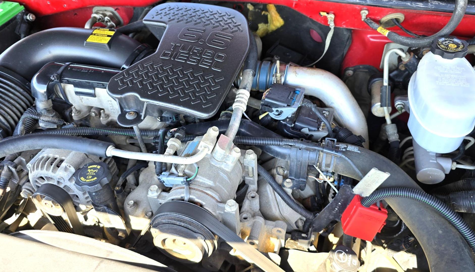 2004 Red /Gray Chevrolet Silverado 3500 Ext. Cab 4WD (1GCJK392X4E) with an 6.6L V8 OHV 32V TURBO DIESEL engine, 6 Speed Manual transmission, located at 450 N Russell, Missoula, MT, 59801, (406) 543-6600, 46.874496, -114.017433 - The Ultimate Unicorn of Chevy Trucks. One Ton Dually, Flatbed, 6.6L Duramax Diesel with a 6 Speed Manual Transmission. And Only 129K Miles! Tires are like New. Air. Cruise. Tilt. Power Windows and Locks. AM FM CD Player, Brush Guard. Headache Rack. Because of the age of this Vehicle, our lenders - Photo#17