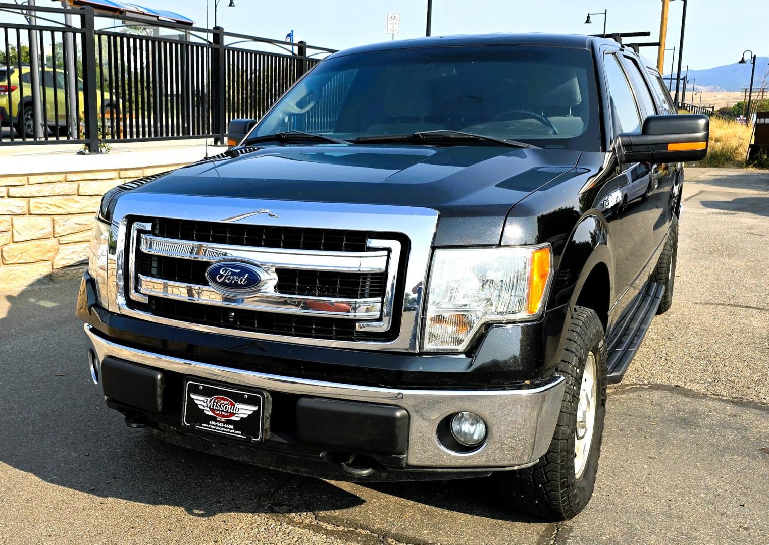 2013 Black /Gray Ford F-150 XLT SuperCrew 4WD (1FTFW1EF6DK) with an 5.0L V8 engine, 6-Speed Automatic transmission, located at 450 N Russell, Missoula, MT, 59801, (406) 543-6600, 46.874496, -114.017433 - High Miles but you wouldn't know it by how well this girl runs. 5.0L V8 Engine. 4WD.. Nice Matching Topper with Racks on top for your canoe. Air. Cruise. Tilt. Power Windows and Locks. Bluetooth Audio and Phone. AM FM XM CD Player. Power Drivers Seat. Excellent Fuel Economy for a V8 Engine. Running - Photo#8