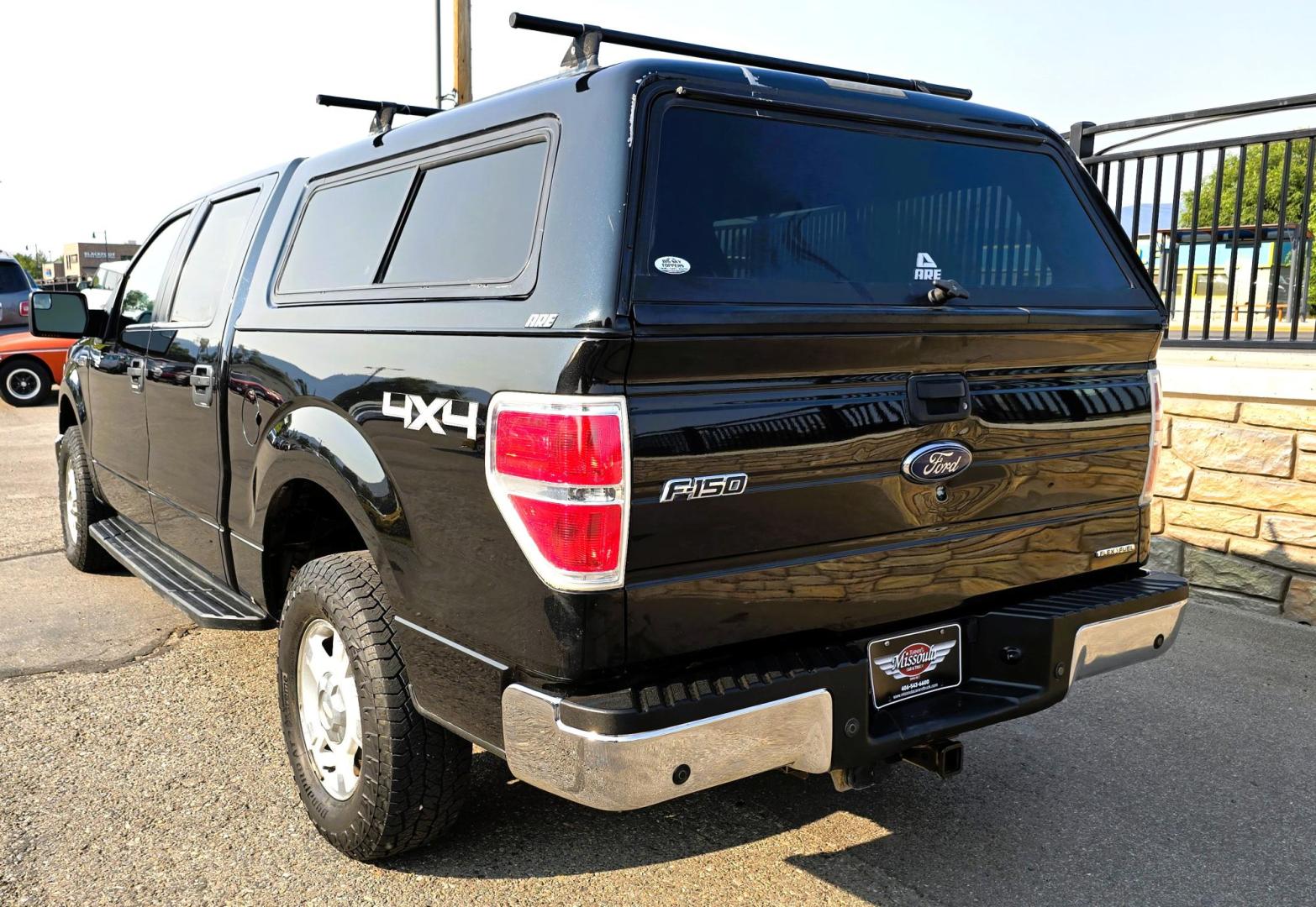 2013 Black /Gray Ford F-150 XLT SuperCrew 4WD (1FTFW1EF6DK) with an 5.0L V8 engine, 6-Speed Automatic transmission, located at 450 N Russell, Missoula, MT, 59801, (406) 543-6600, 46.874496, -114.017433 - High Miles but you wouldn't know it by how well this girl runs. 5.0L V8 Engine. 4WD.. Nice Matching Topper with Racks on top for your canoe. Air. Cruise. Tilt. Power Windows and Locks. Bluetooth Audio and Phone. AM FM XM CD Player. Power Drivers Seat. Excellent Fuel Economy for a V8 Engine. Running - Photo#10