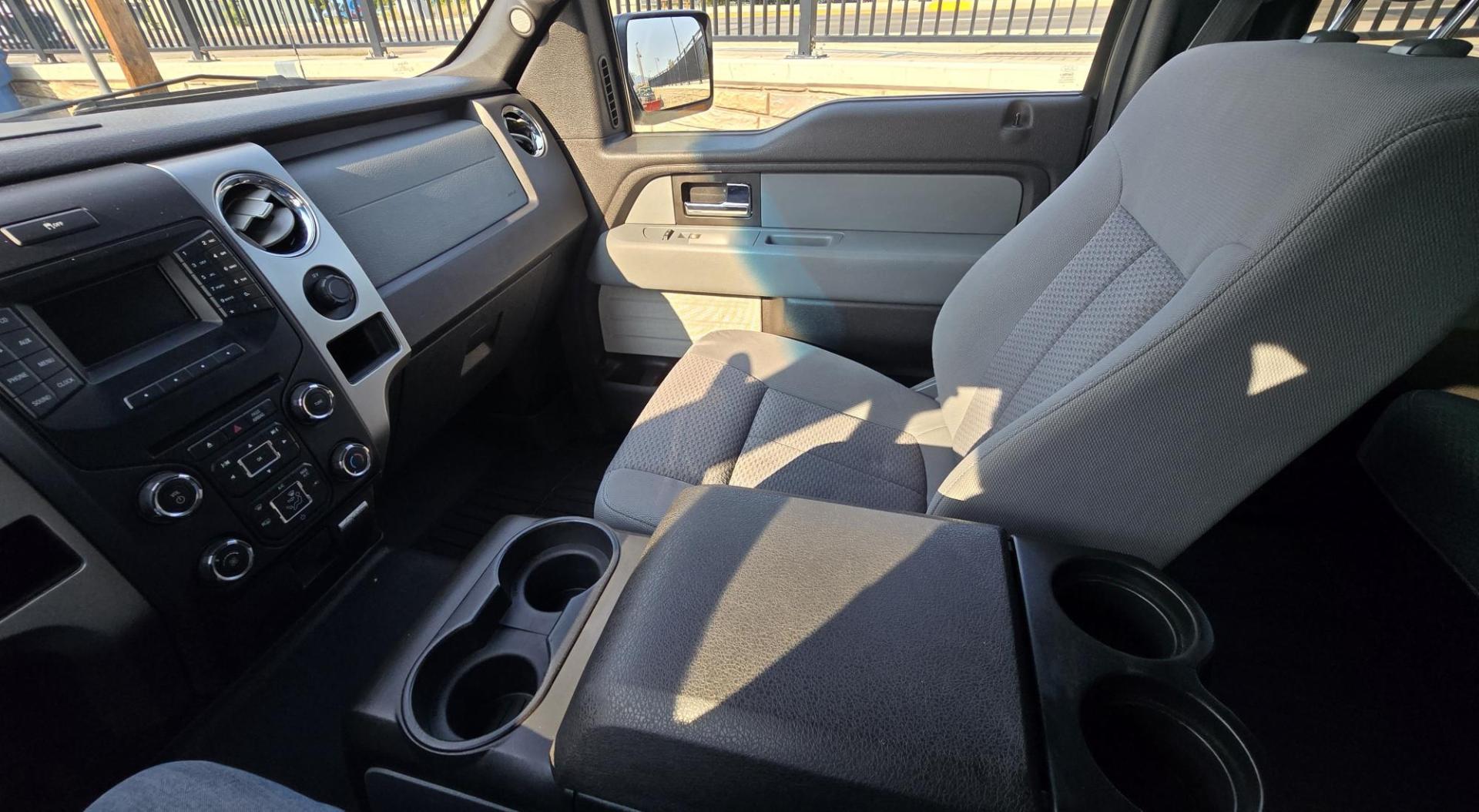 2013 Black /Gray Ford F-150 XLT SuperCrew 4WD (1FTFW1EF6DK) with an 5.0L V8 engine, 6-Speed Automatic transmission, located at 450 N Russell, Missoula, MT, 59801, (406) 543-6600, 46.874496, -114.017433 - High Miles but you wouldn't know it by how well this girl runs. 5.0L V8 Engine. 4WD.. Nice Matching Topper with Racks on top for your canoe. Air. Cruise. Tilt. Power Windows and Locks. Bluetooth Audio and Phone. AM FM XM CD Player. Power Drivers Seat. Excellent Fuel Economy for a V8 Engine. Running - Photo#16