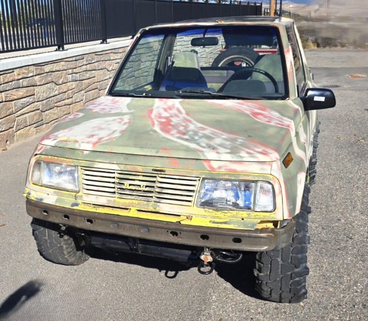 1993 Camo Geo Tracker 2-Door 4WD (2CNBJ18U7P6) with an 1.6L L4 SOHC 8V engine, 4 Speed Manual transmission, located at 450 N Russell, Missoula, MT, 59801, (406) 543-6600, 46.874496, -114.017433 - One Owner with only 34K Miles. Not the prettiest but runs amazing. Owner bought it to keep at his cabin it it has very little use. Somewhere along the way he lost the top to it. 1.6L I4 Engine. 4 Speed Manual Transmission. 4WD. Seats Five. More comfortable than an ATV with similar attributes. B - Photo#2