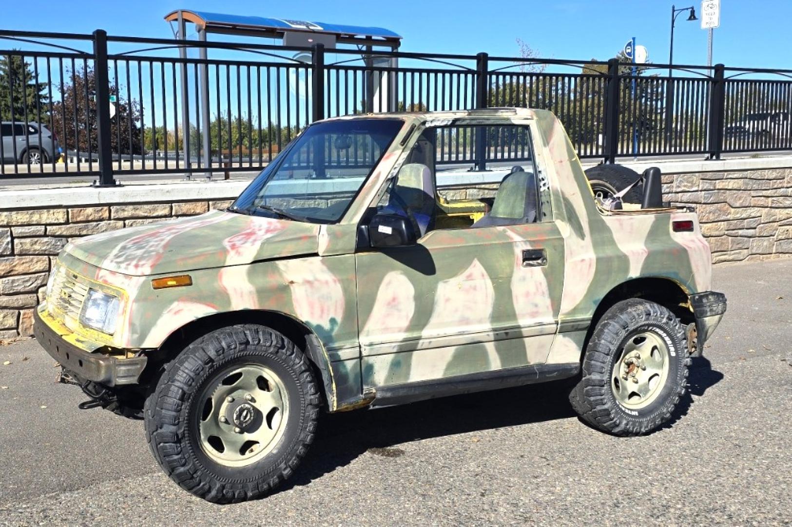 1993 Camo Geo Tracker 2-Door 4WD (2CNBJ18U7P6) with an 1.6L L4 SOHC 8V engine, 4 Speed Manual transmission, located at 450 N Russell, Missoula, MT, 59801, (406) 543-6600, 46.874496, -114.017433 - One Owner with only 34K Miles. Not the prettiest but runs amazing. Owner bought it to keep at his cabin it it has very little use. Somewhere along the way he lost the top to it. 1.6L I4 Engine. 4 Speed Manual Transmission. 4WD. Seats Five. More comfortable than an ATV with similar attributes. B - Photo#0