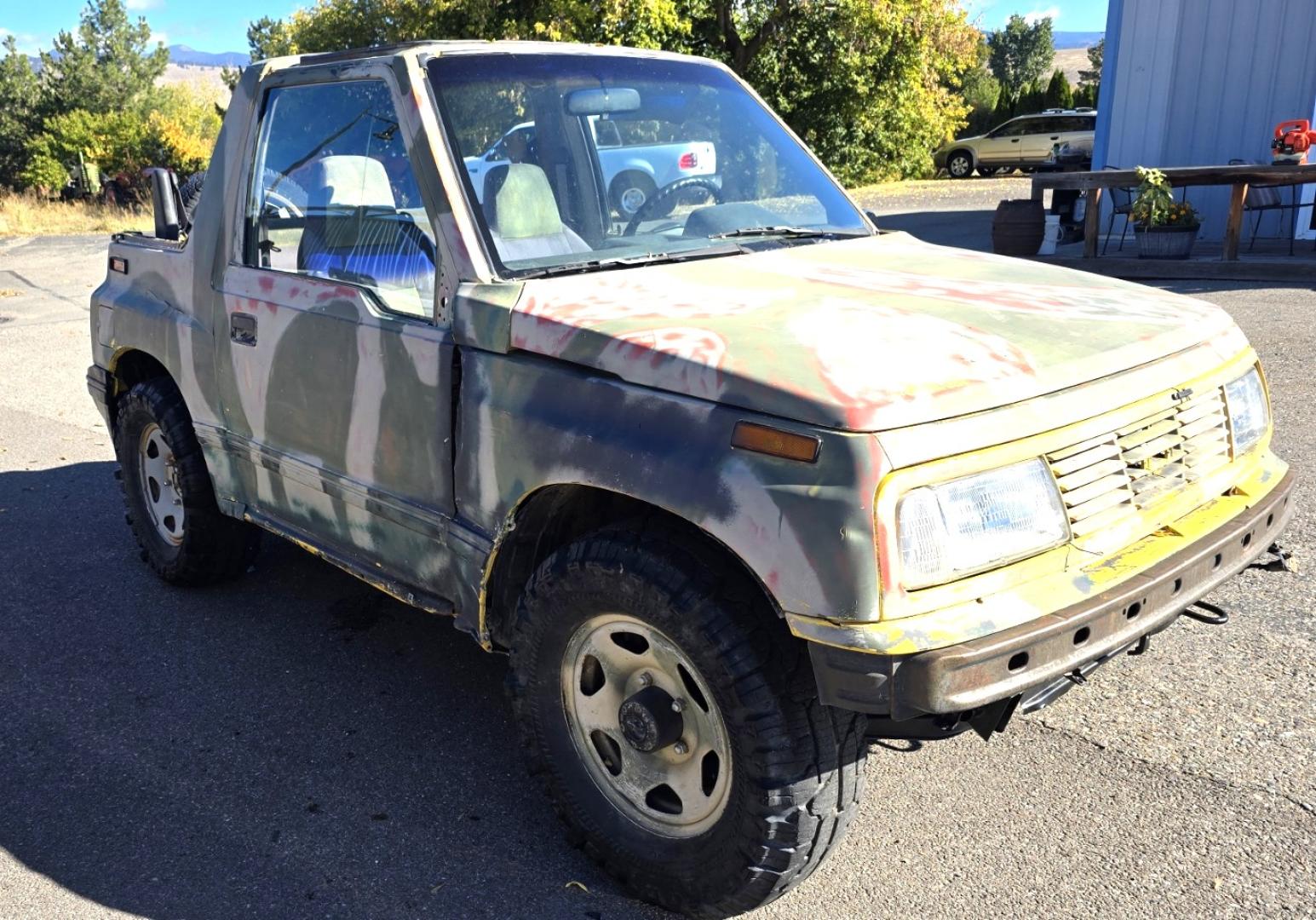 1993 Camo Geo Tracker 2-Door 4WD (2CNBJ18U7P6) with an 1.6L L4 SOHC 8V engine, 4 Speed Manual transmission, located at 450 N Russell, Missoula, MT, 59801, (406) 543-6600, 46.874496, -114.017433 - One Owner with only 34K Miles. Not the prettiest but runs amazing. Owner bought it to keep at his cabin it it has very little use. Somewhere along the way he lost the top to it. 1.6L I4 Engine. 4 Speed Manual Transmission. 4WD. Seats Five. More comfortable than an ATV with similar attributes. B - Photo#3