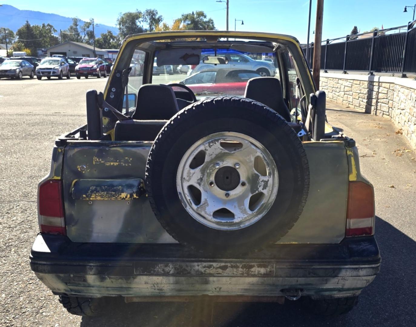 1993 Camo Geo Tracker 2-Door 4WD (2CNBJ18U7P6) with an 1.6L L4 SOHC 8V engine, 4 Speed Manual transmission, located at 450 N Russell, Missoula, MT, 59801, (406) 543-6600, 46.874496, -114.017433 - One Owner with only 34K Miles. Not the prettiest but runs amazing. Owner bought it to keep at his cabin it it has very little use. Somewhere along the way he lost the top to it. 1.6L I4 Engine. 4 Speed Manual Transmission. 4WD. Seats Five. More comfortable than an ATV with similar attributes. B - Photo#5