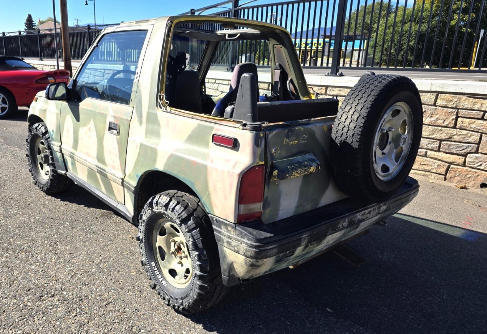 1993 Camo Geo Tracker 2-Door 4WD (2CNBJ18U7P6) with an 1.6L L4 SOHC 8V engine, 4 Speed Manual transmission, located at 450 N Russell, Missoula, MT, 59801, (406) 543-6600, 46.874496, -114.017433 - One Owner with only 34K Miles. Not the prettiest but runs amazing. Owner bought it to keep at his cabin it it has very little use. Somewhere along the way he lost the top to it. 1.6L I4 Engine. 4 Speed Manual Transmission. 4WD. Seats Five. More comfortable than an ATV with similar attributes. B - Photo#6