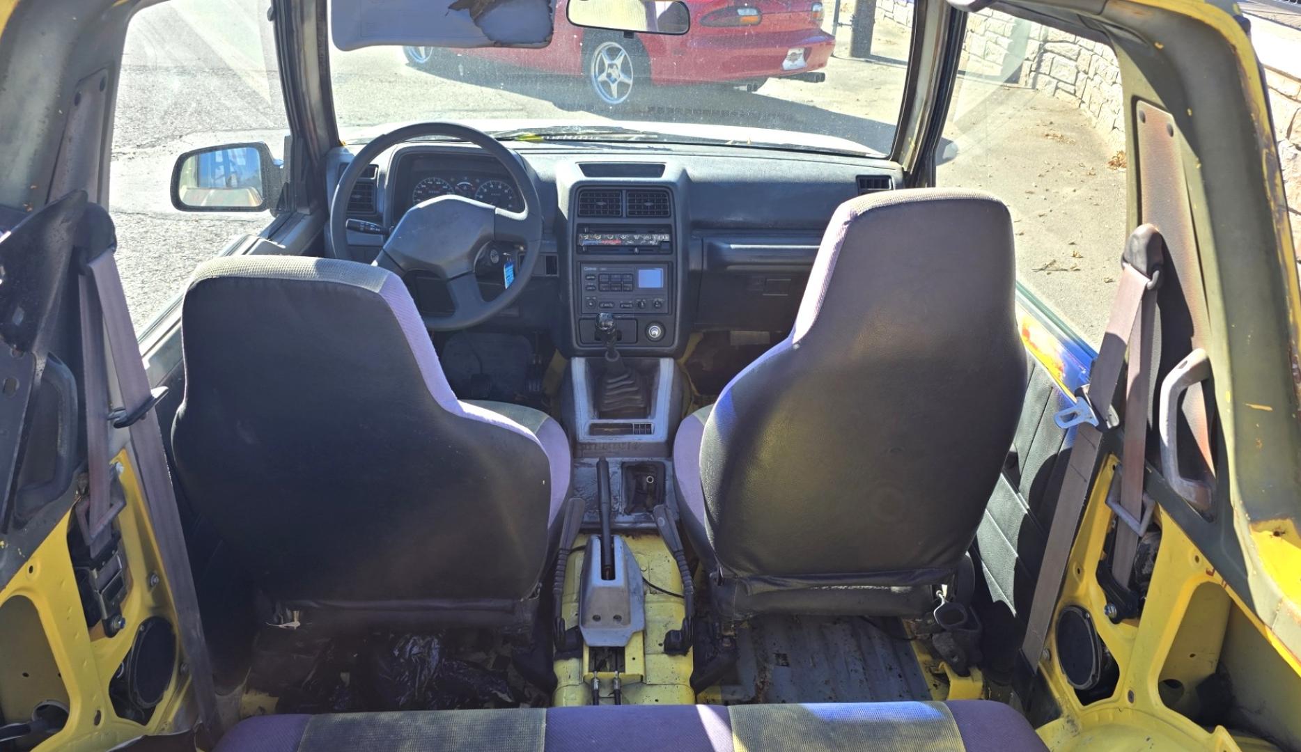 1993 Camo Geo Tracker 2-Door 4WD (2CNBJ18U7P6) with an 1.6L L4 SOHC 8V engine, 4 Speed Manual transmission, located at 450 N Russell, Missoula, MT, 59801, (406) 543-6600, 46.874496, -114.017433 - One Owner with only 34K Miles. Not the prettiest but runs amazing. Owner bought it to keep at his cabin it it has very little use. Somewhere along the way he lost the top to it. 1.6L I4 Engine. 4 Speed Manual Transmission. 4WD. Seats Five. More comfortable than an ATV with similar attributes. B - Photo#7