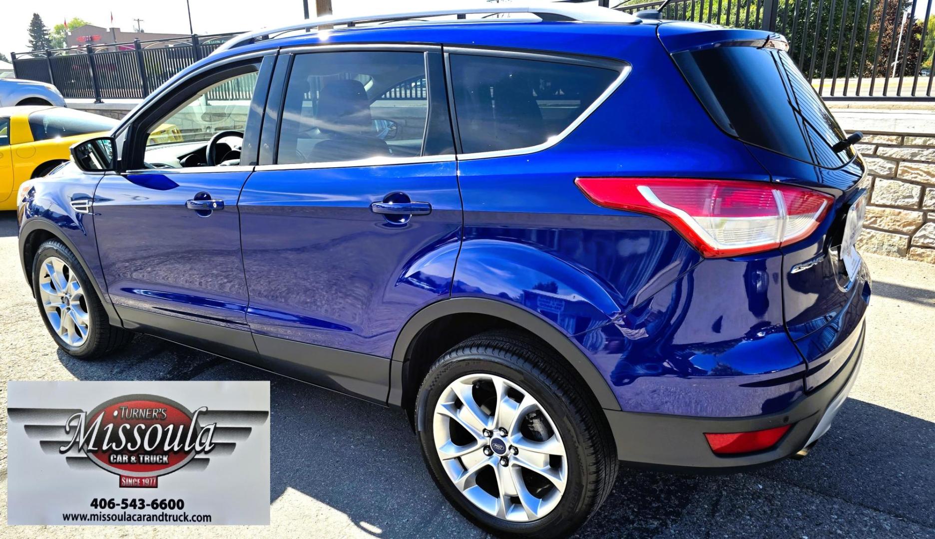 2014 Blue /Black Ford Escape Titanium 4WD (1FMCU9J98EU) with an 2.0L L4 DOHC 16V engine, 6-Speed Automatic transmission, located at 450 N Russell, Missoula, MT, 59801, (406) 543-6600, 46.874496, -114.017433 - Clean One Owner AWD SUV. 2.0L I4 EcoBoost Engine. Automatic Transmission. Air. Cruise. Tilt. Power Drivers Seat. Heated Front Seats. AM FM CD Bluetooth. Microsoft Sync Technology. Touchscreen. Navigation. Power Windows and Locks. Backup Camera. Remote Start. Clean Title and Carfax. - Photo#6