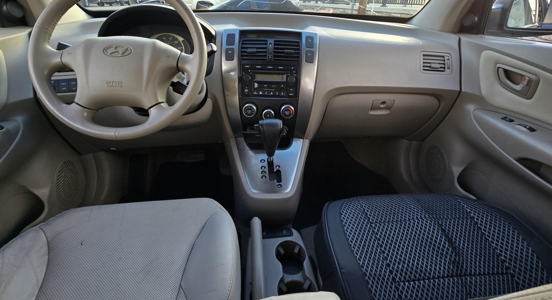 2005 Blue /White Hyundai Tucson GLS 2.7 4WD (KM8JN72D65U) with an 2.6L V6 DOHC 24V engine, 4-Speed Automatic Overdrive transmission, located at 450 N Russell, Missoula, MT, 59801, (406) 543-6600, 46.874496, -114.017433 - Hard to come across Affordable 2 Owner AWD SUV. Spunky 2.7L V6 Engine. Automatic Transmission. Power Sunroof. Power Windows and Locks. Heated Seats. Air. Cruise. Tilt. AM FM Cassette. Excellent Tires. Passenger Front Seat is a little worn so it has a seat cover on it. Because of the age, financi - Photo#12