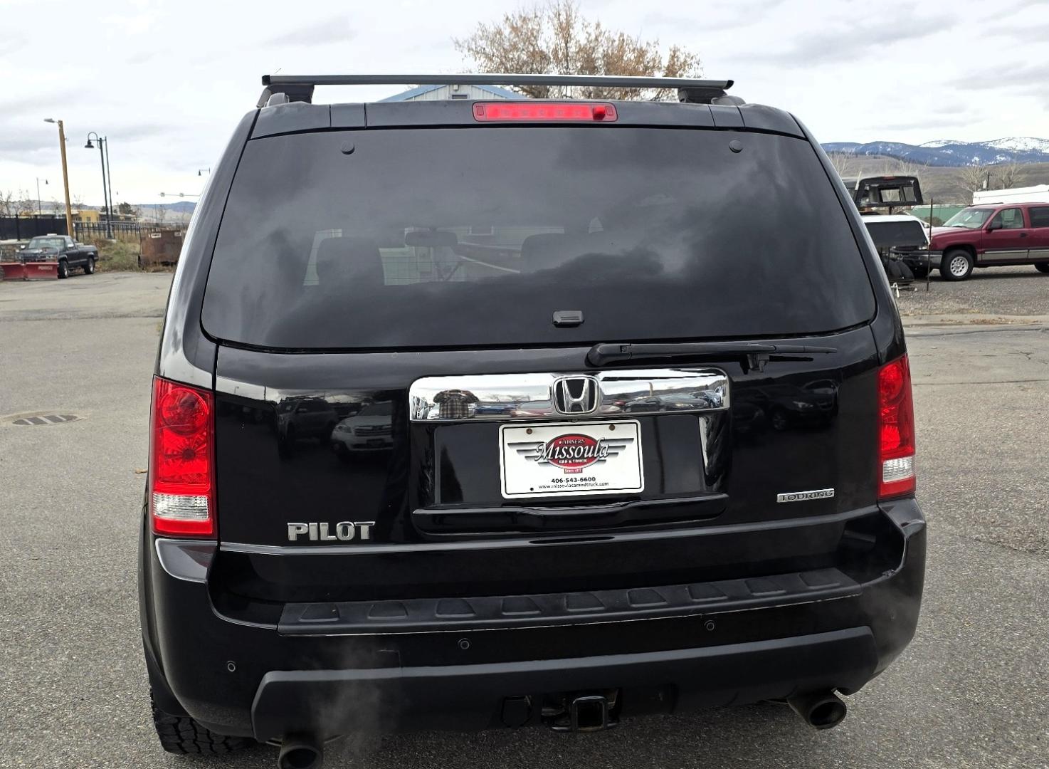 2009 Black /Black Honda Pilot Touring 4WD with RES & Navigation (5FNYF48919B) with an 3.5L V6 SOHC 24V engine, 5-Speed Automatic Overdrive transmission, located at 450 N Russell, Missoula, MT, 59801, (406) 543-6600, 46.874496, -114.017433 - Yes it's a lot of miles but the motor has been well maintained. New Timing Belt only has 18K Miles on it. Runs Amazing. 3.5L V6 has lots of pep. 4WD Works Great., Nice All terrain tires are like new, Heated Power Leather Front Seats. 3rd Row Seating in the back. Power Sun Roof. Power Windows and Loc - Photo#5