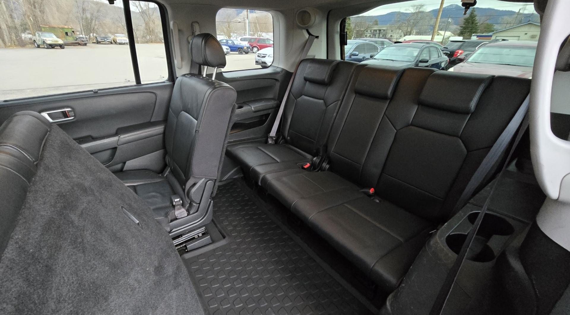 2009 Black /Black Honda Pilot Touring 4WD with RES & Navigation (5FNYF48919B) with an 3.5L V6 SOHC 24V engine, 5-Speed Automatic Overdrive transmission, located at 450 N Russell, Missoula, MT, 59801, (406) 543-6600, 46.874496, -114.017433 - Yes it's a lot of miles but the motor has been well maintained. New Timing Belt only has 18K Miles on it. Runs Amazing. 3.5L V6 has lots of pep. 4WD Works Great., Nice All terrain tires are like new, Heated Power Leather Front Seats. 3rd Row Seating in the back. Power Sun Roof. Power Windows and Loc - Photo#10