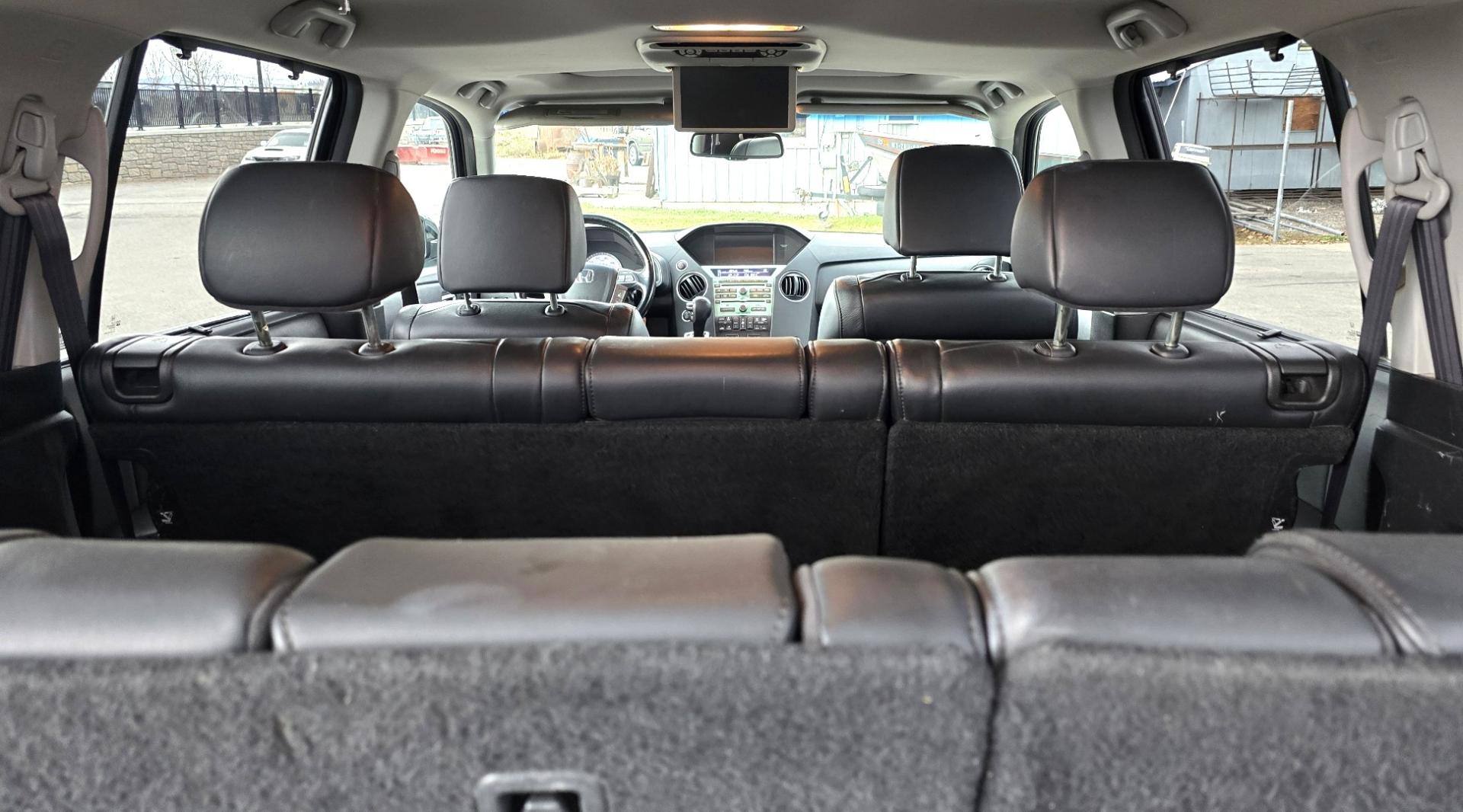 2009 Black /Black Honda Pilot Touring 4WD with RES & Navigation (5FNYF48919B) with an 3.5L V6 SOHC 24V engine, 5-Speed Automatic Overdrive transmission, located at 450 N Russell, Missoula, MT, 59801, (406) 543-6600, 46.874496, -114.017433 - Yes it's a lot of miles but the motor has been well maintained. New Timing Belt only has 18K Miles on it. Runs Amazing. 3.5L V6 has lots of pep. 4WD Works Great., Nice All terrain tires are like new, Heated Power Leather Front Seats. 3rd Row Seating in the back. Power Sun Roof. Power Windows and Loc - Photo#12