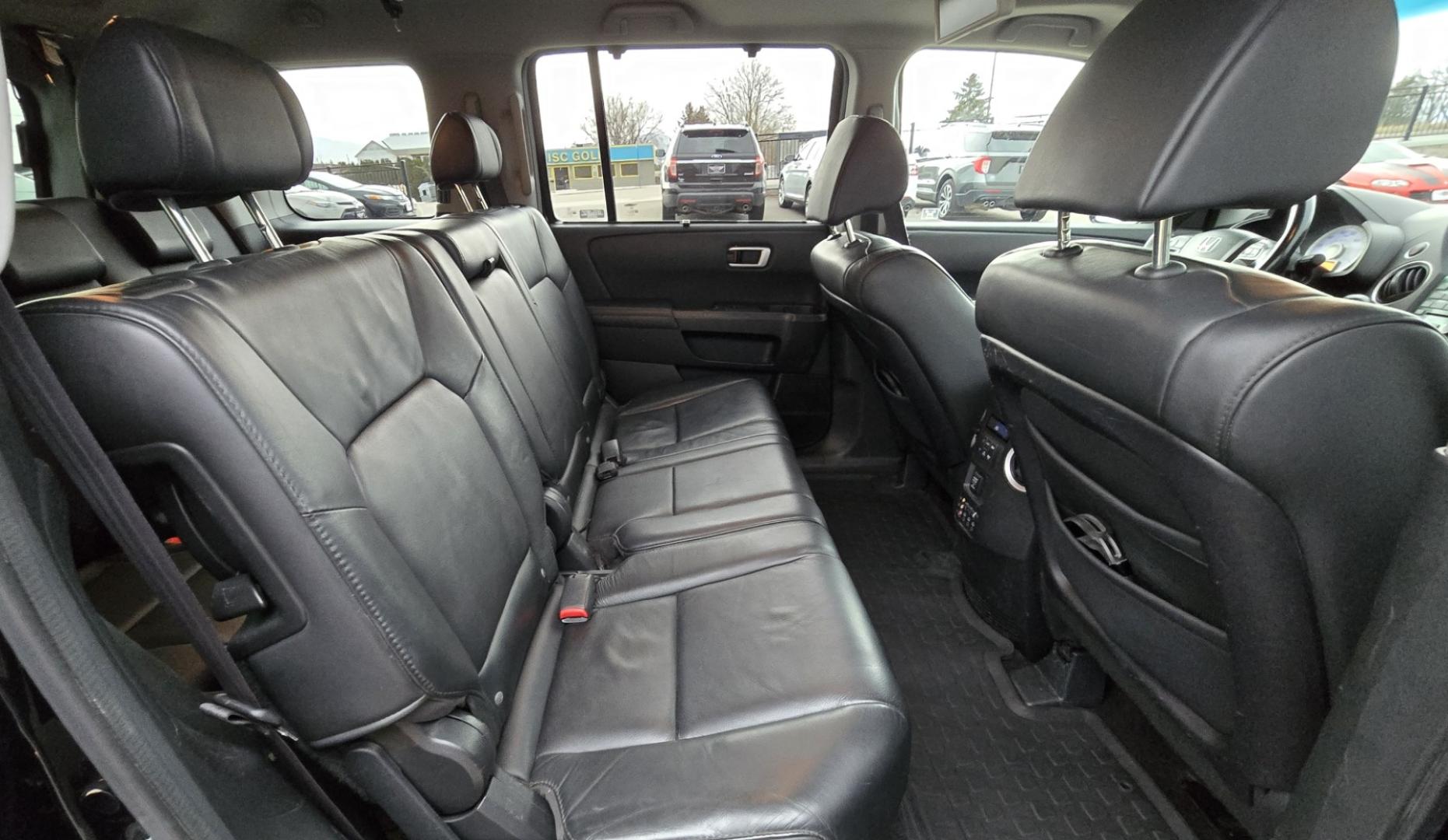 2009 Black /Black Honda Pilot Touring 4WD with RES & Navigation (5FNYF48919B) with an 3.5L V6 SOHC 24V engine, 5-Speed Automatic Overdrive transmission, located at 450 N Russell, Missoula, MT, 59801, (406) 543-6600, 46.874496, -114.017433 - Yes it's a lot of miles but the motor has been well maintained. New Timing Belt only has 18K Miles on it. Runs Amazing. 3.5L V6 has lots of pep. 4WD Works Great., Nice All terrain tires are like new, Heated Power Leather Front Seats. 3rd Row Seating in the back. Power Sun Roof. Power Windows and Loc - Photo#13