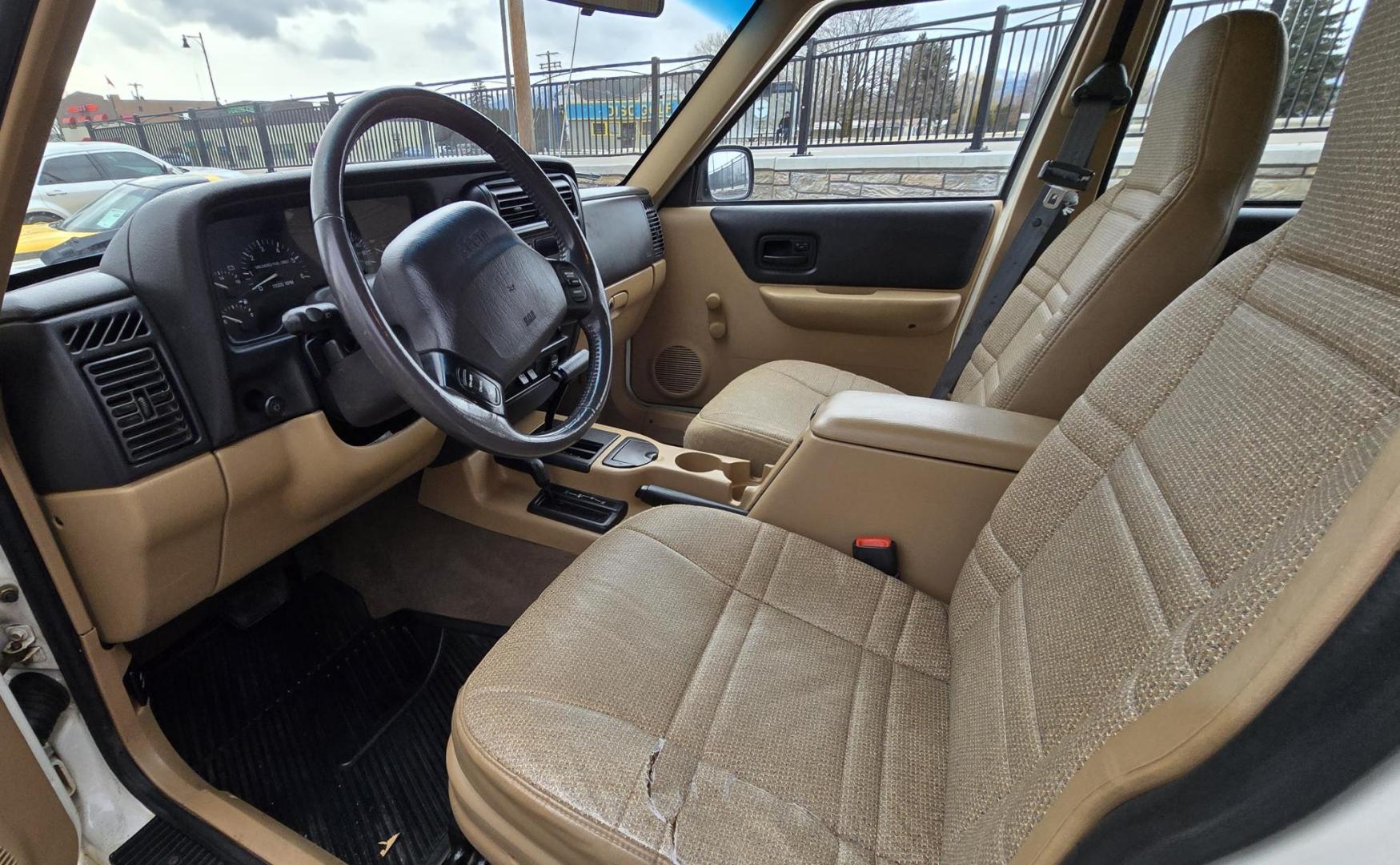 1999 White /Tan Jeep Cherokee SE 4-Door 4WD (1J4FF28S9XL) with an 4.0L L6 OHV 12V engine, Automatic transmission, located at 450 N Russell, Missoula, MT, 59801, (406) 543-6600, 46.874496, -114.017433 - 4WD Jeep Cherokee with the almost bullet proof 4.0L Straight Six Engine. Excellent Miles for the Year. Automatic Transmission. Air. Cruise. Tilt. Roof Rack. Nice Wheels. Does have the clear coat peeling on the passenger side. Because of the age, our lenders do not offer financing on this vehicle. - Photo#9
