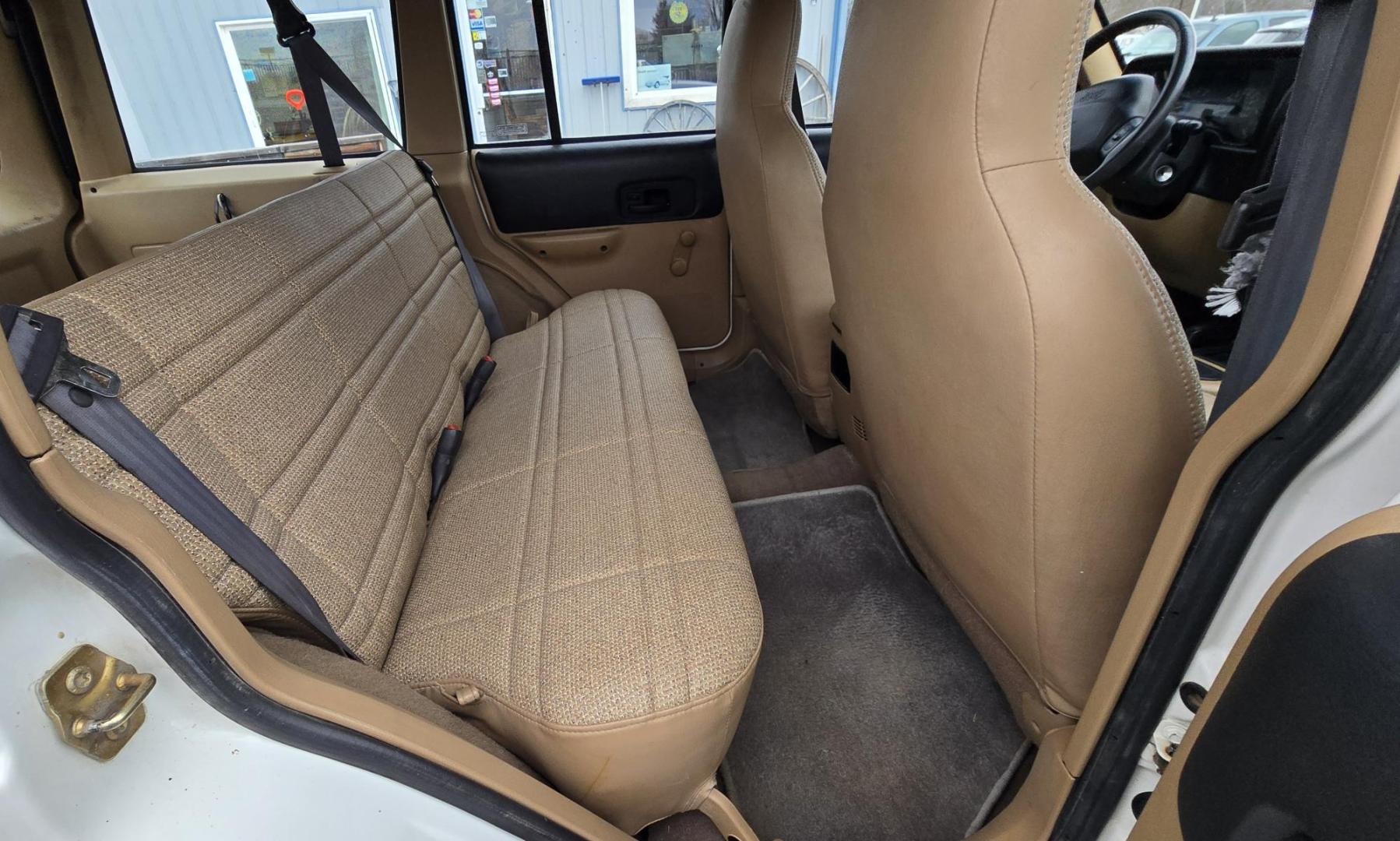 1999 White /Tan Jeep Cherokee SE 4-Door 4WD (1J4FF28S9XL) with an 4.0L L6 OHV 12V engine, Automatic transmission, located at 450 N Russell, Missoula, MT, 59801, (406) 543-6600, 46.874496, -114.017433 - 4WD Jeep Cherokee with the almost bullet proof 4.0L Straight Six Engine. Excellent Miles for the Year. Automatic Transmission. Air. Cruise. Tilt. Roof Rack. Nice Wheels. Does have the clear coat peeling on the passenger side. Because of the age, our lenders do not offer financing on this vehicle. - Photo#12