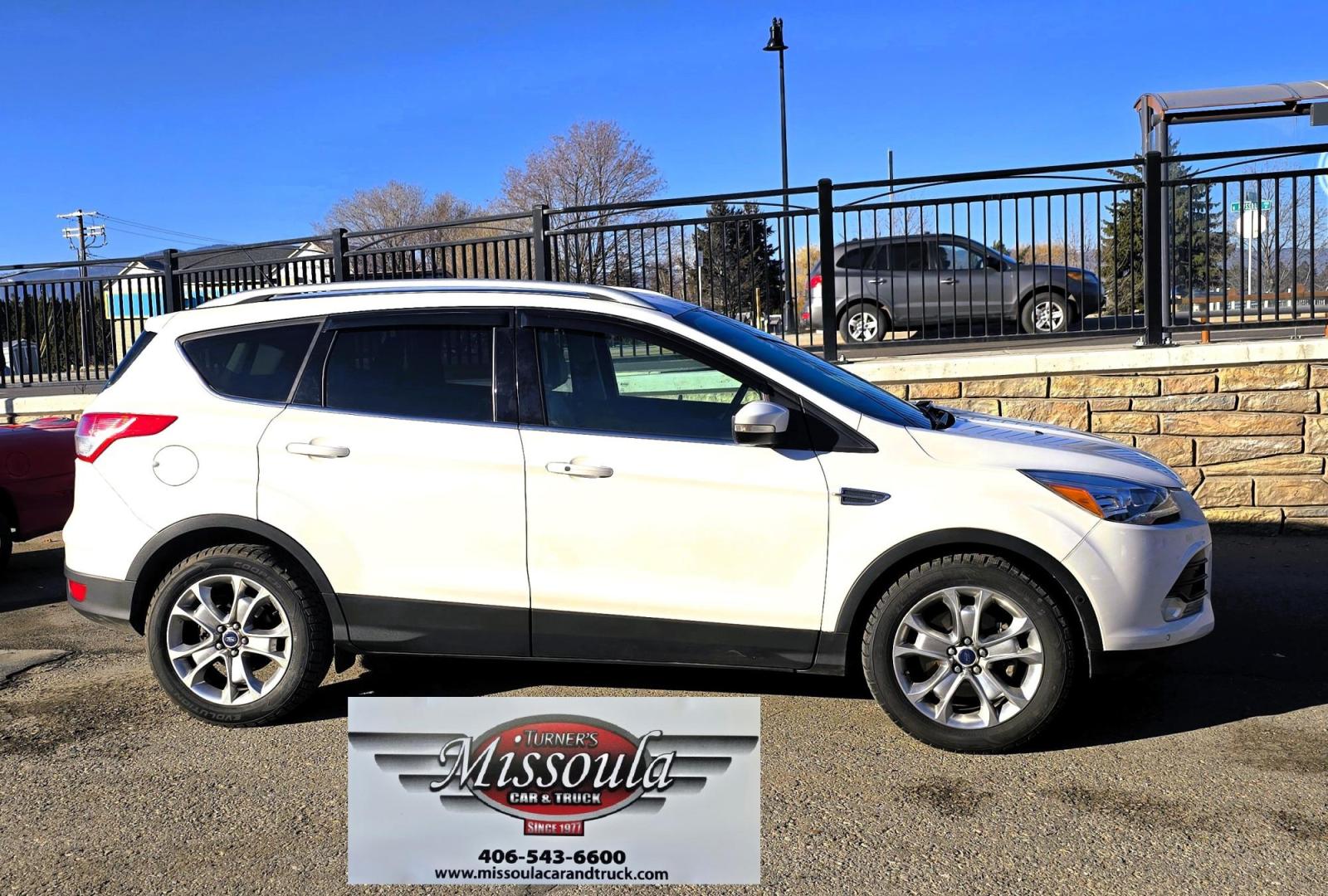 2014 White /Tan Ford Escape Titanium FWD (1FMCU0J95EU) with an 2.0L L4 DOHC 16V engine, 6-Speed Automatic transmission, located at 450 N Russell, Missoula, MT, 59801, (406) 543-6600, 46.874496, -114.017433 - Straight little SUV with a 2.0L I4 Eco Boost Engine. 6 Speed Select Shift Automatic Transmission. Navigation. Heated Leather Seats. Power Drivers Seat. Backup Camera. Blind Spot Detection System. Power Windows and Locks. Power Rear Lift Gate. Sync Voice Activated System. Bluetooth Audio and Phone. A - Photo#1