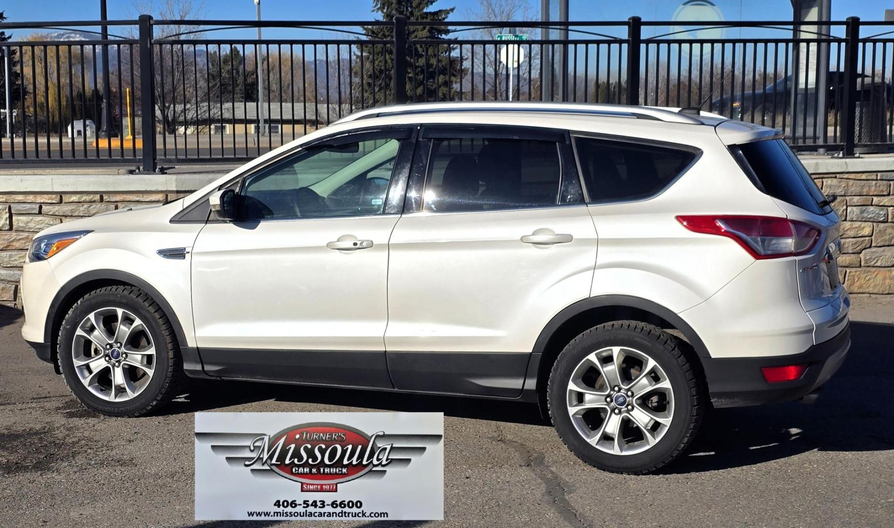 2014 White /Tan Ford Escape Titanium FWD (1FMCU0J95EU) with an 2.0L L4 DOHC 16V engine, 6-Speed Automatic transmission, located at 450 N Russell, Missoula, MT, 59801, (406) 543-6600, 46.874496, -114.017433 - Straight little SUV with a 2.0L I4 Eco Boost Engine. 6 Speed Select Shift Automatic Transmission. Navigation. Heated Leather Seats. Power Drivers Seat. Backup Camera. Blind Spot Detection System. Power Windows and Locks. Power Rear Lift Gate. Sync Voice Activated System. Bluetooth Audio and Phone. A - Photo#5