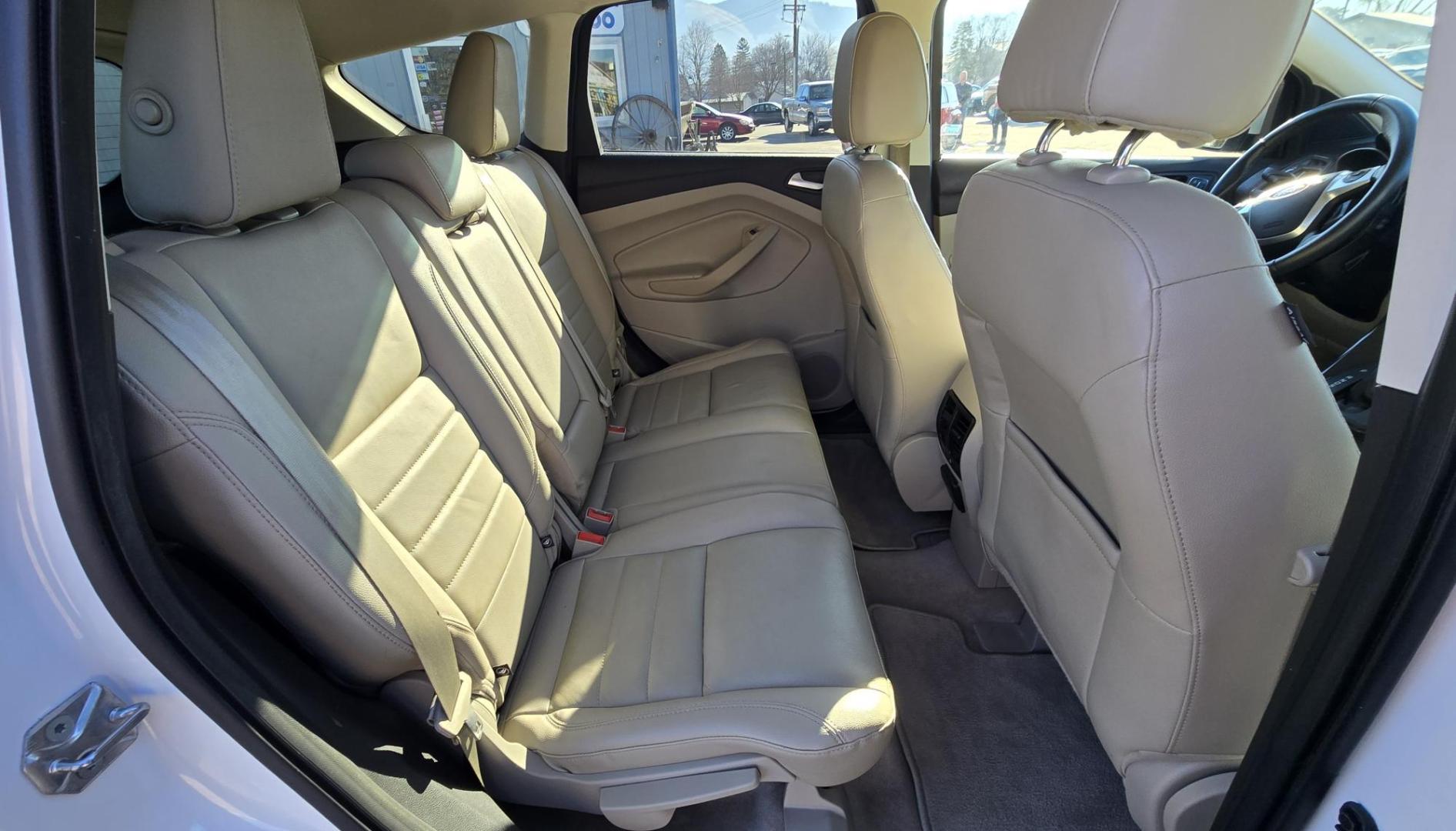 2014 White /Tan Ford Escape Titanium FWD (1FMCU0J95EU) with an 2.0L L4 DOHC 16V engine, 6-Speed Automatic transmission, located at 450 N Russell, Missoula, MT, 59801, (406) 543-6600, 46.874496, -114.017433 - Straight little SUV with a 2.0L I4 Eco Boost Engine. 6 Speed Select Shift Automatic Transmission. Navigation. Heated Leather Seats. Power Drivers Seat. Backup Camera. Blind Spot Detection System. Power Windows and Locks. Power Rear Lift Gate. Sync Voice Activated System. Bluetooth Audio and Phone. A - Photo#9