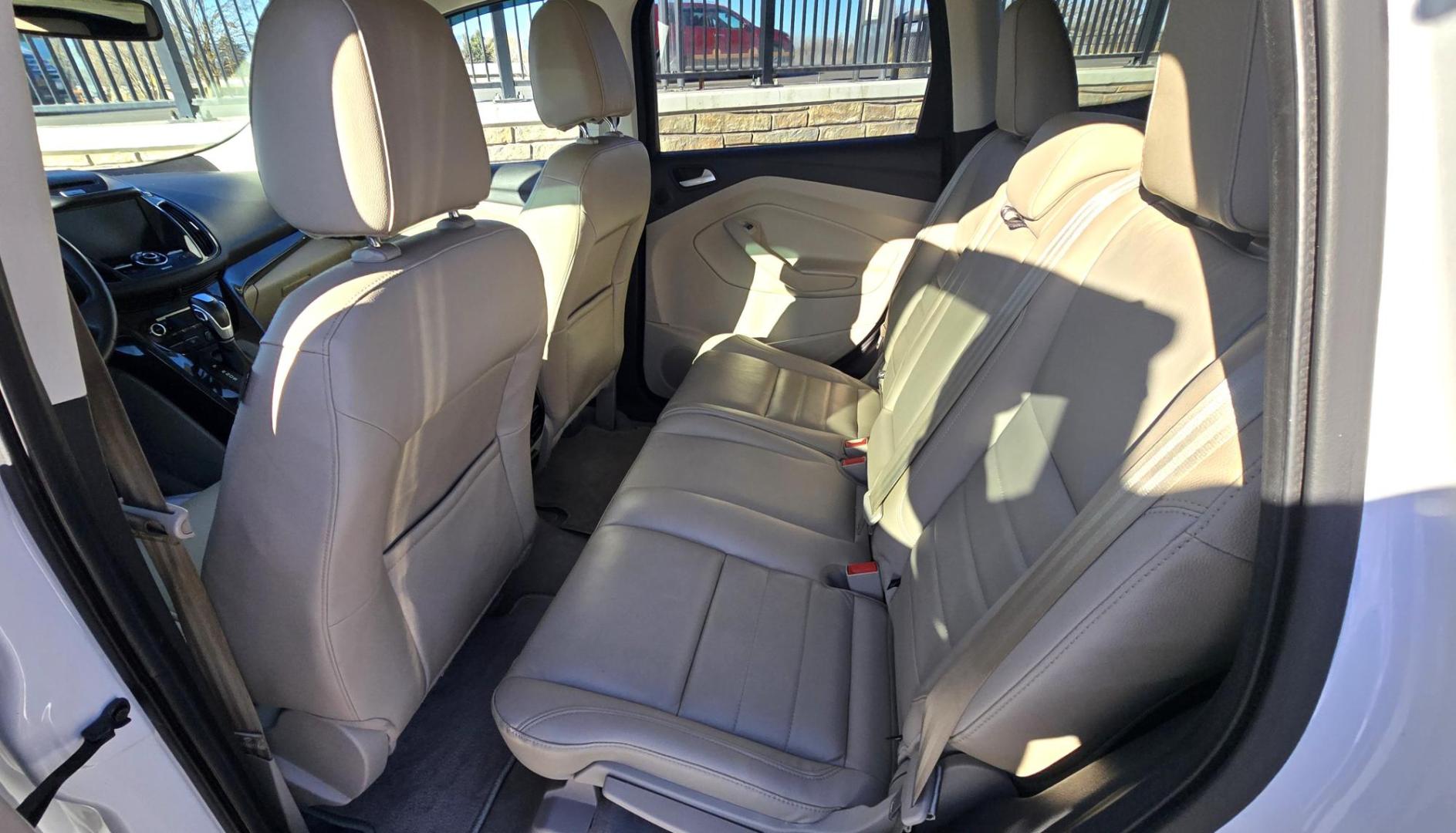 2014 White /Tan Ford Escape Titanium FWD (1FMCU0J95EU) with an 2.0L L4 DOHC 16V engine, 6-Speed Automatic transmission, located at 450 N Russell, Missoula, MT, 59801, (406) 543-6600, 46.874496, -114.017433 - Straight little SUV with a 2.0L I4 Eco Boost Engine. 6 Speed Select Shift Automatic Transmission. Navigation. Heated Leather Seats. Power Drivers Seat. Backup Camera. Blind Spot Detection System. Power Windows and Locks. Power Rear Lift Gate. Sync Voice Activated System. Bluetooth Audio and Phone. A - Photo#11