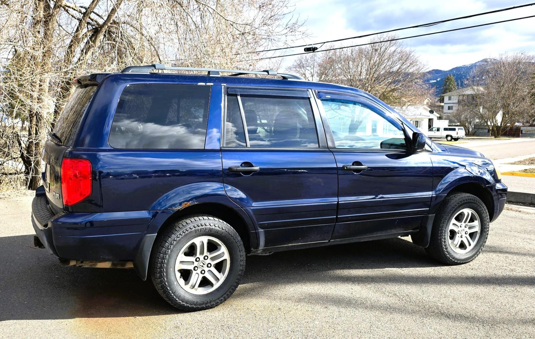2004 Blue /Black Honda Pilot EX w/ Leather and DVD (2HKYF18664H) with an 3.5L V6 SOHC 24V engine, 5-Speed Automatic Overdrive transmission, located at 450 N Russell, Missoula, MT, 59801, (406) 543-6600, 46.874496, -114.017433 - Great Running AWD Honda. 3.5L V6 Engine. 3rd Row Seating. Heated Front Seats. Power Drivers Seat. Rear Entertainment. Air. Cruise. Tilt. Power Windows and Locks. Remote Start. Has some rust and the front seats are worn. Has an Air Bag Light so we are selling AS-IS. Clean Title and Carfax. No Fina - Photo#3