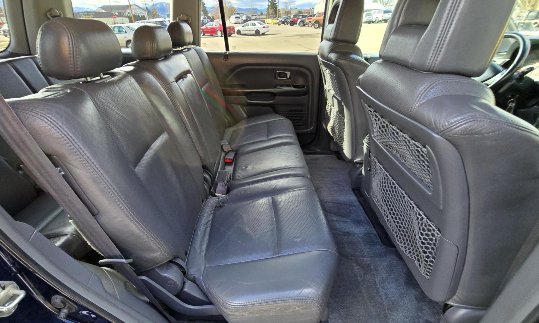 2004 Blue /Black Honda Pilot EX w/ Leather and DVD (2HKYF18664H) with an 3.5L V6 SOHC 24V engine, 5-Speed Automatic Overdrive transmission, located at 450 N Russell, Missoula, MT, 59801, (406) 543-6600, 46.874496, -114.017433 - Great Running AWD Honda. 3.5L V6 Engine. 3rd Row Seating. Heated Front Seats. Power Drivers Seat. Rear Entertainment. Air. Cruise. Tilt. Power Windows and Locks. Remote Start. Has some rust and the front seats are worn. Has an Air Bag Light so we are selling AS-IS. Clean Title and Carfax. No Fina - Photo#12